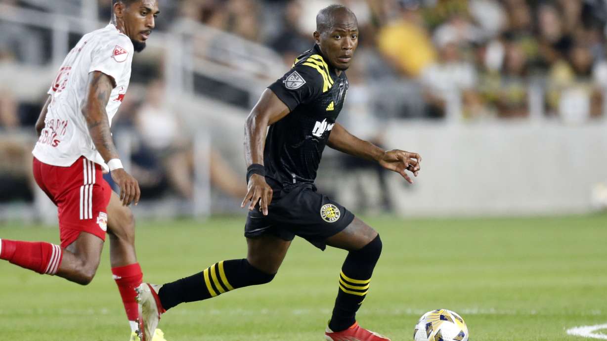 FILE - Columbus Crew midfielder Darlington Nagbe, right, controls the ball in front of New York Red Bulls forward Fabio during an MLS soccer match in Columbus, Ohio, on Sept. 14, 2021.