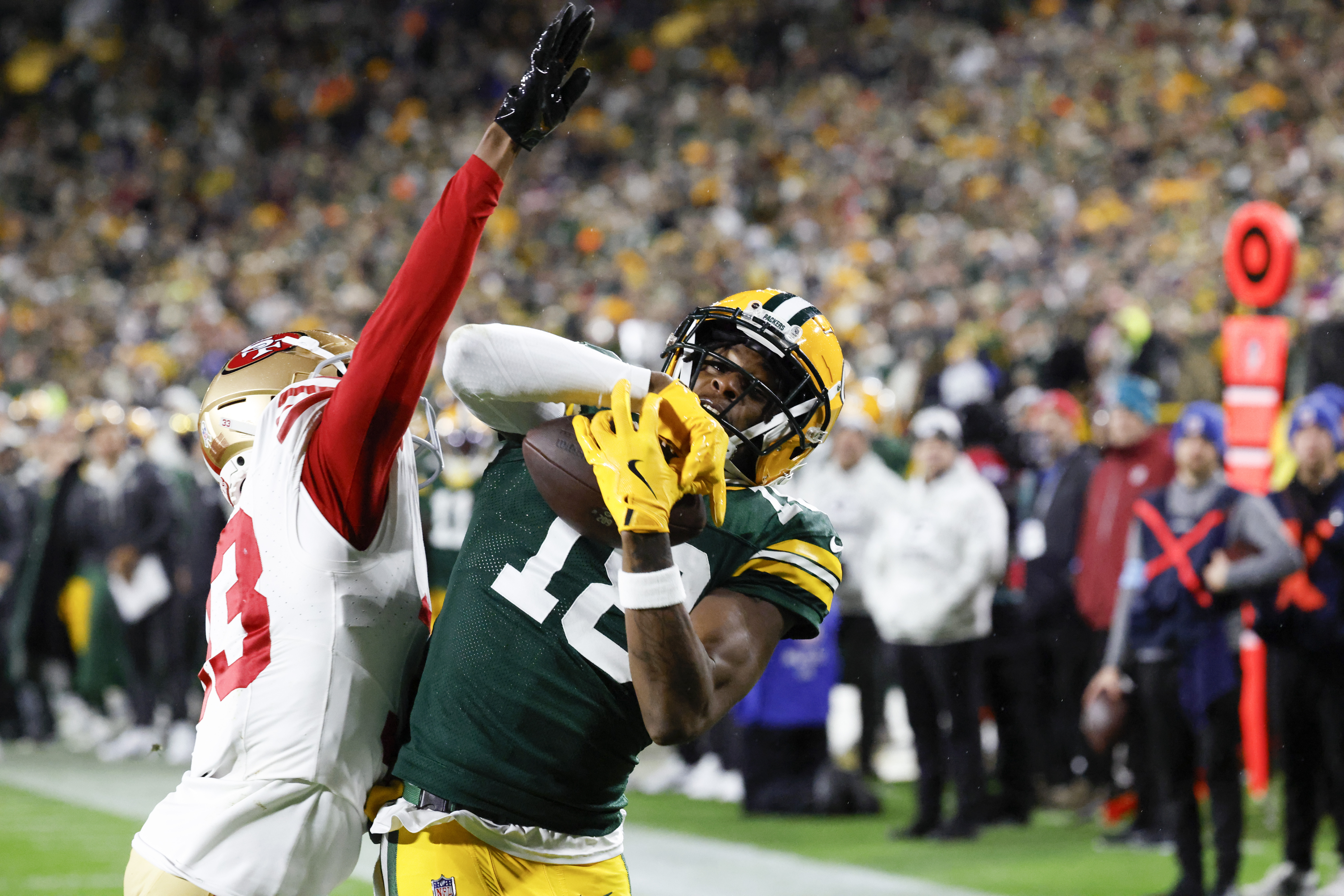 Green Bay Packers wide receiver Malik Heath (18) catches a touchdown pass against San Francisco 49ers cornerback Rock Ya-Sin (33) during the second half of an NFL football game on Sunday, Nov. 24, 2024 in Green Bay, Wis.