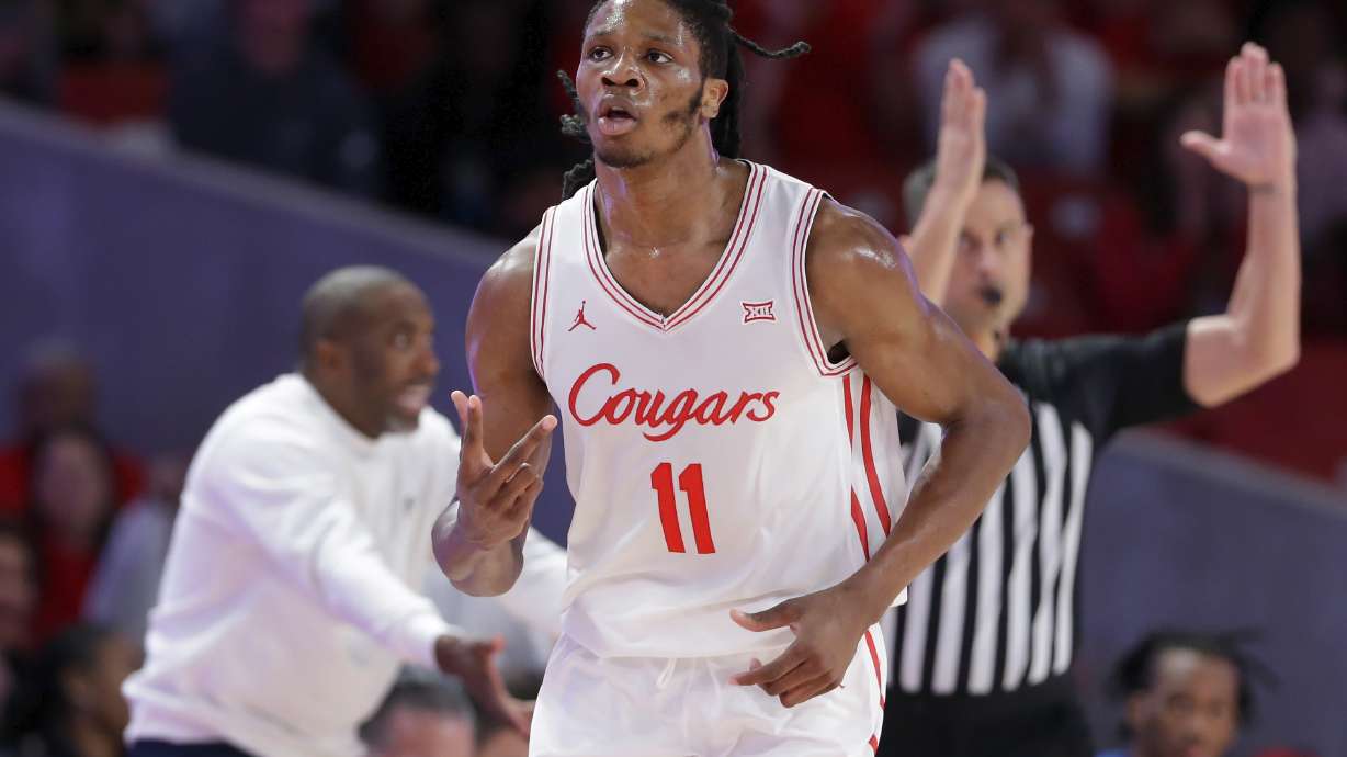 Houston forward Joseph Tugler (11) reacts after sinking a 3-point basket against Hofstra during the first half of an NCAA college basketball game Friday, Nov. 22, 2024, in Houston.