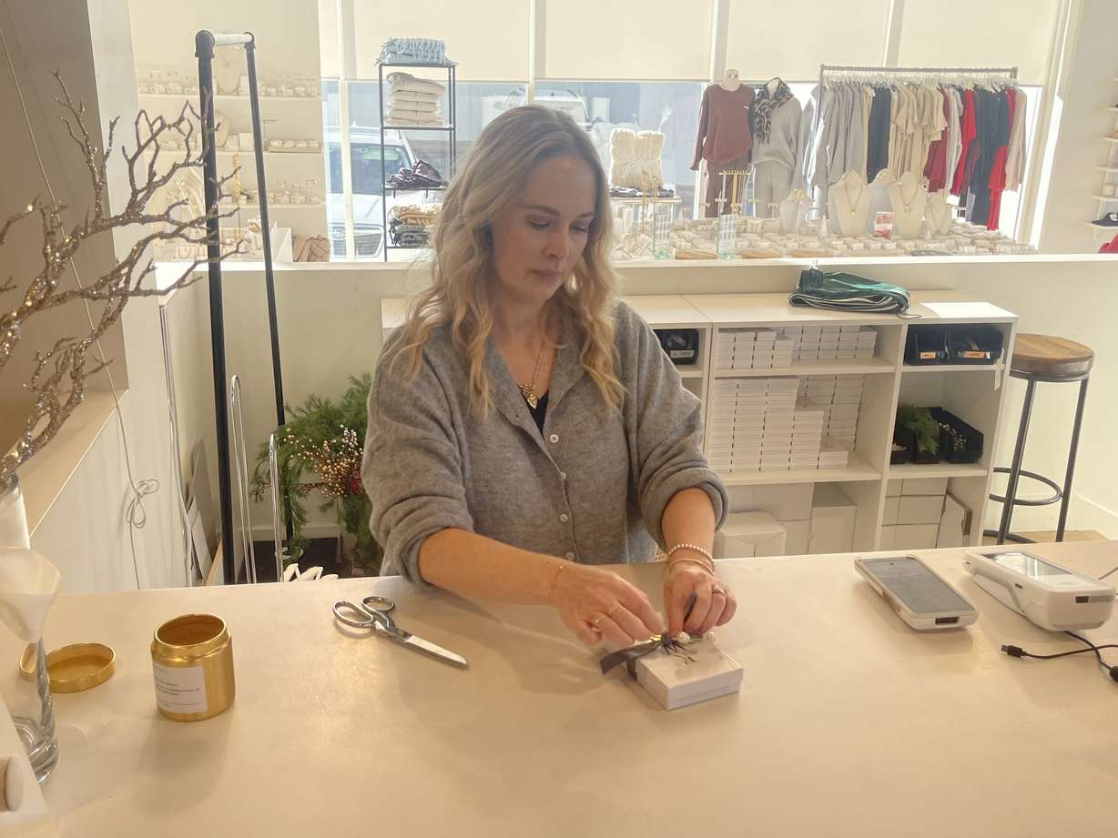 Katie Waltman Boutique employee Brynn Whitchurch wraps a gift inside the store on Monday. Utahns are feeling better about the economy than they were last year as consumer sentiment has increased nearly 17% over the last year, signaling that customers are starting to regain their sense of purchasing power.