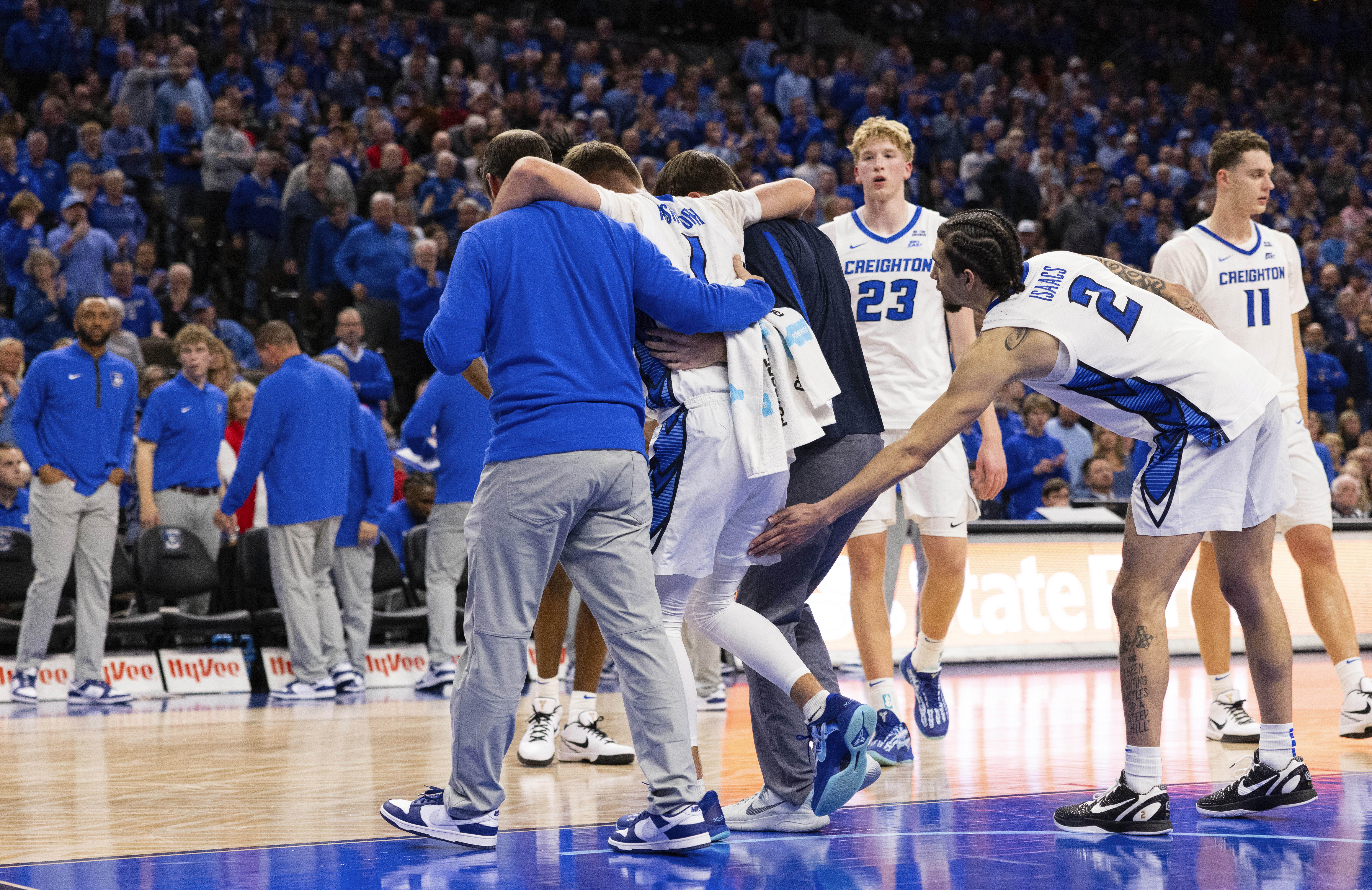 Creighton's Pop Isaacs (2) reaches out to Steven Ashworth (1) who leaves the court with assistance following an injury during the second half of an NCAA college basketball game against Nebraska, Friday, Nov. 22, 2024, in Omaha, Neb. 