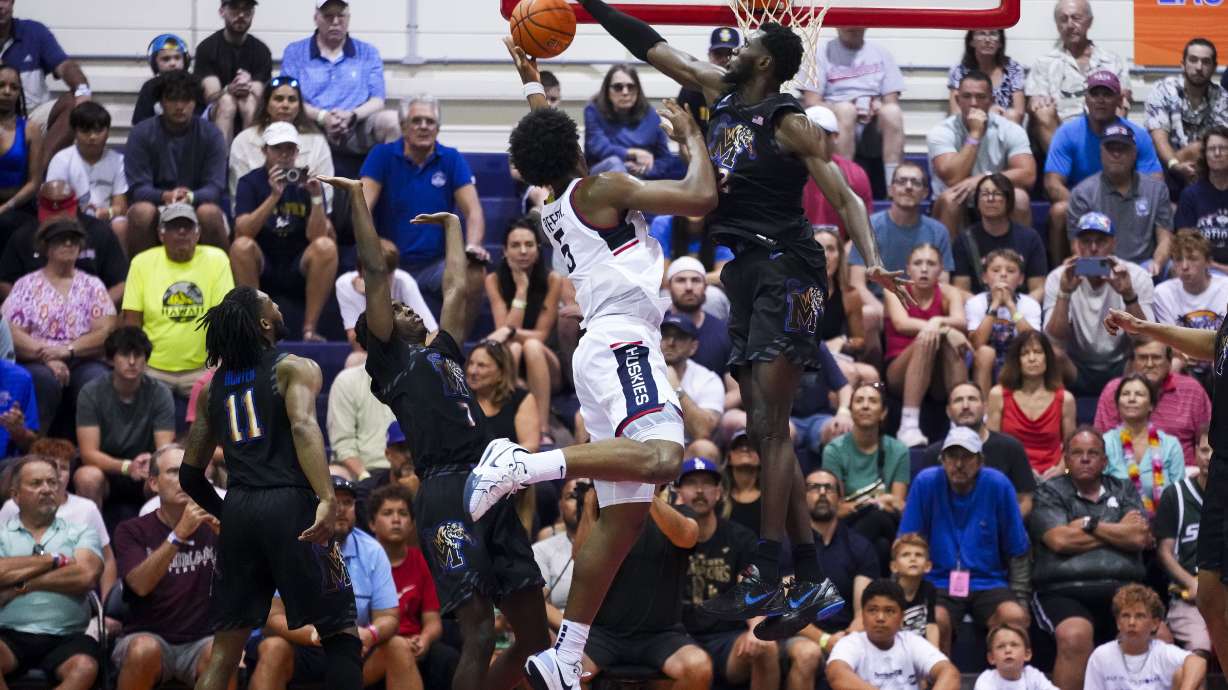 UConn center Tarris Reed Jr. (5) has his shot blocked by Memphis center Moussa Cisse, right, during the first half of an NCAA college basketball game at the Maui Invitational Monday, Nov. 25, 2024, in Lahaina, Hawaii.