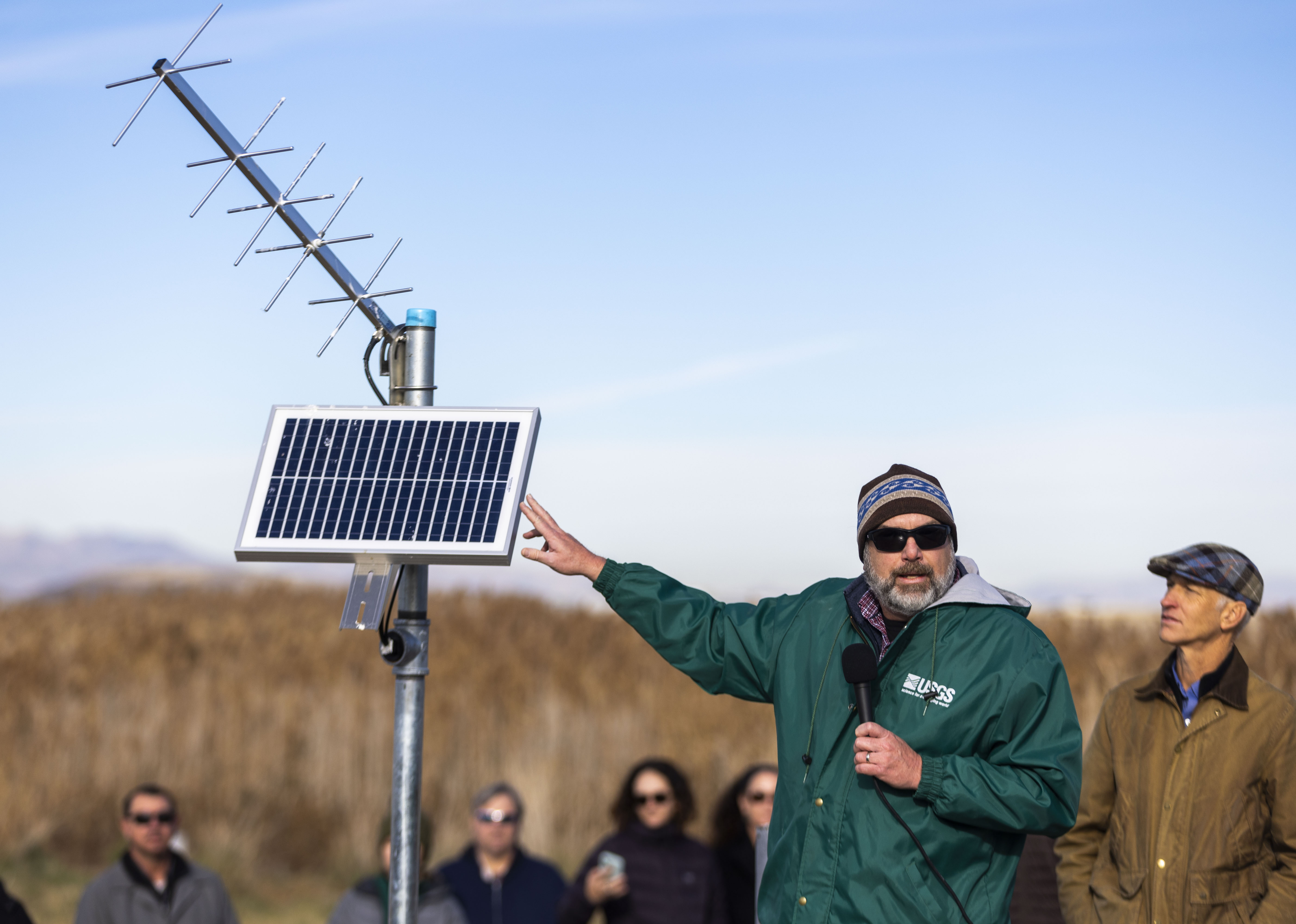 Ryan Rowland gestures to a part of a new stream gauge monitoring device at the announcement of a $3 million enhancement to monitoring efforts of the Great Salt Lake at the Ogden Bay Waterfowl Management Area in Ogden on Monday.