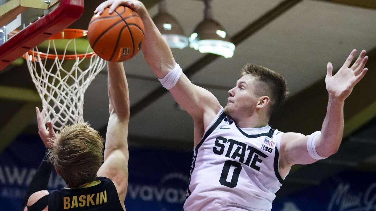 Michigan State forward Jaxon Kohler (0) blocks a shot from Colorado forward Trevor Baskin, left, during the second half of an NCAA college basketball game at the Maui Invitational Monday, Nov. 25, 2024, in Lahaina, Hawaii. Michigan State won 72-56.