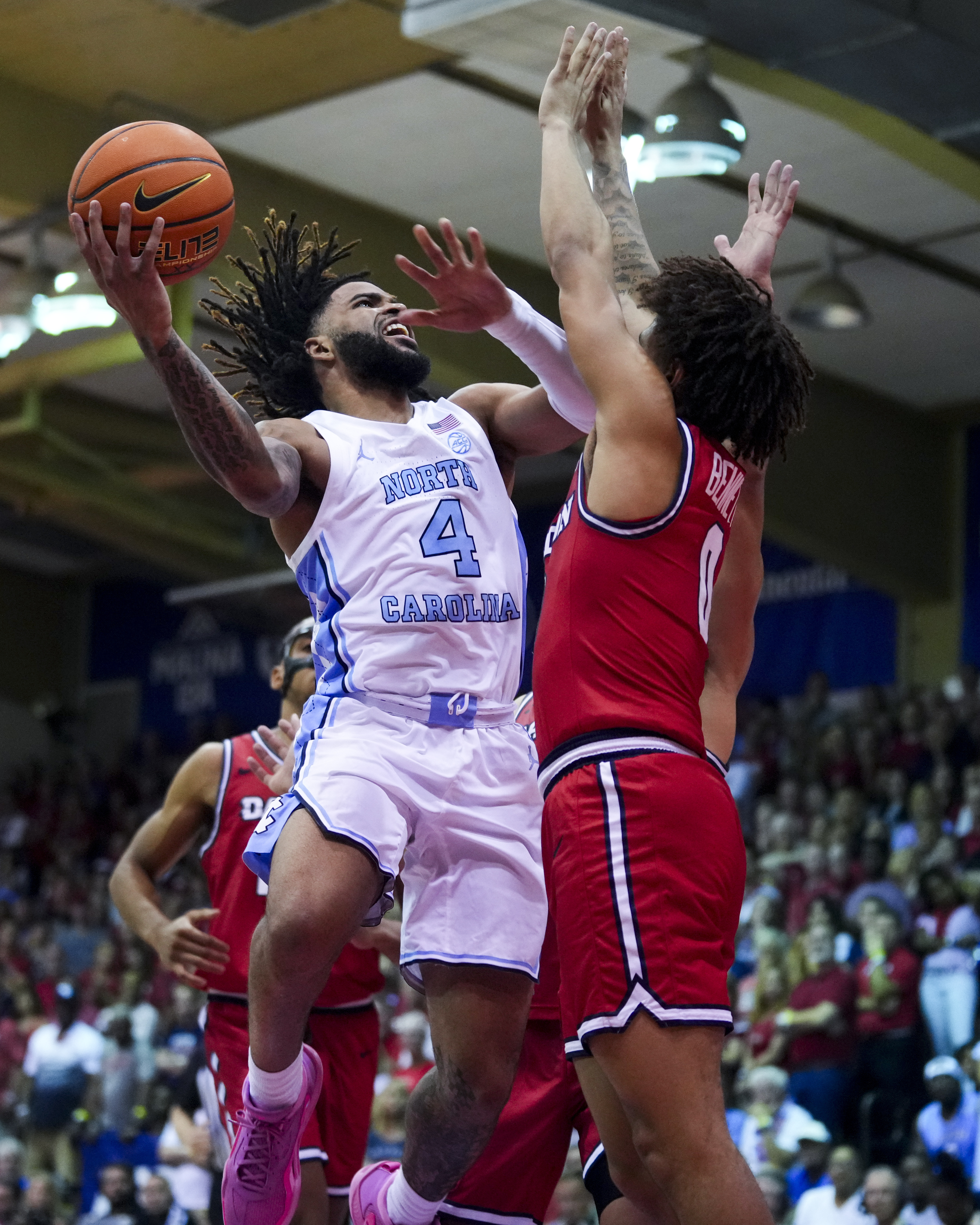 North Carolina guard RJ Davis (4) goes to the basket against Dayton guard Javon Bennett (0) during the second half of an NCAA college basketball game at the Maui Invitational Monday, Nov. 25, 2024, in Lahaina, Hawaii.