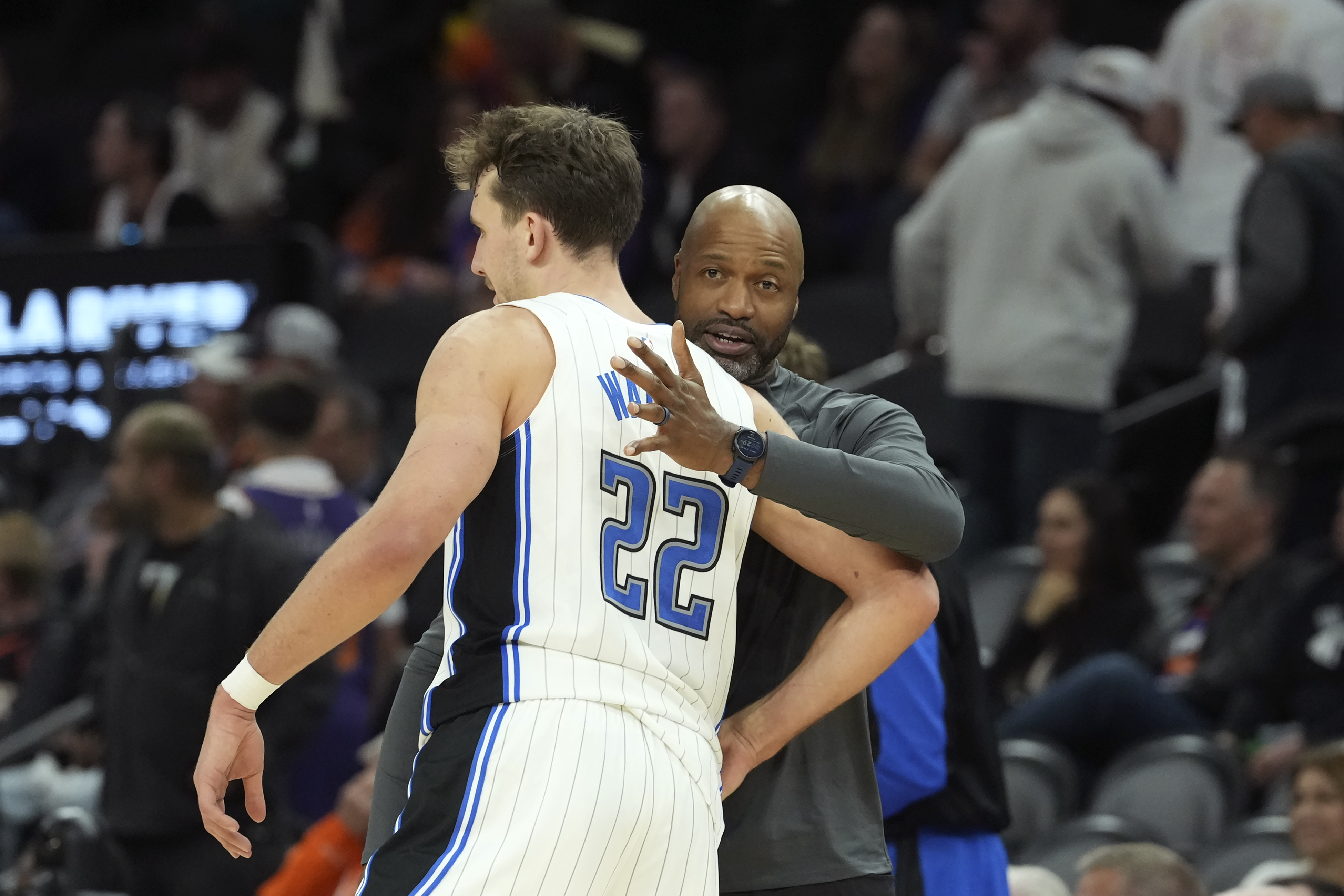 Orlando Magic forward Franz Wagner (22) celebrates with Magic head coach Jamahl Mosley, right, in the closing moments of the second half of an NBA basketball game against the Phoenix Suns, Monday, Nov. 18, 2024, in Phoenix. 