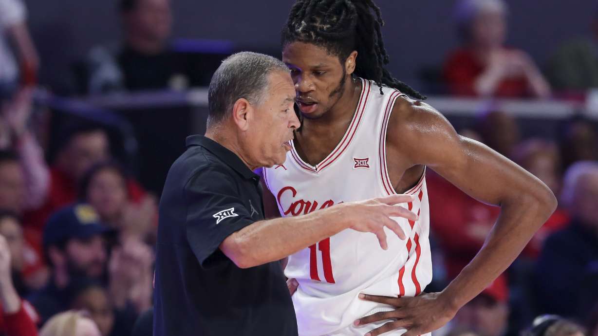 Houston head coach Kelvin Sampson, left, talks with forward Joseph Tugler (11) at the bench during the second half of an NCAA college basketball game against Hofstra, Friday, Nov. 22, 2024, in Houston.