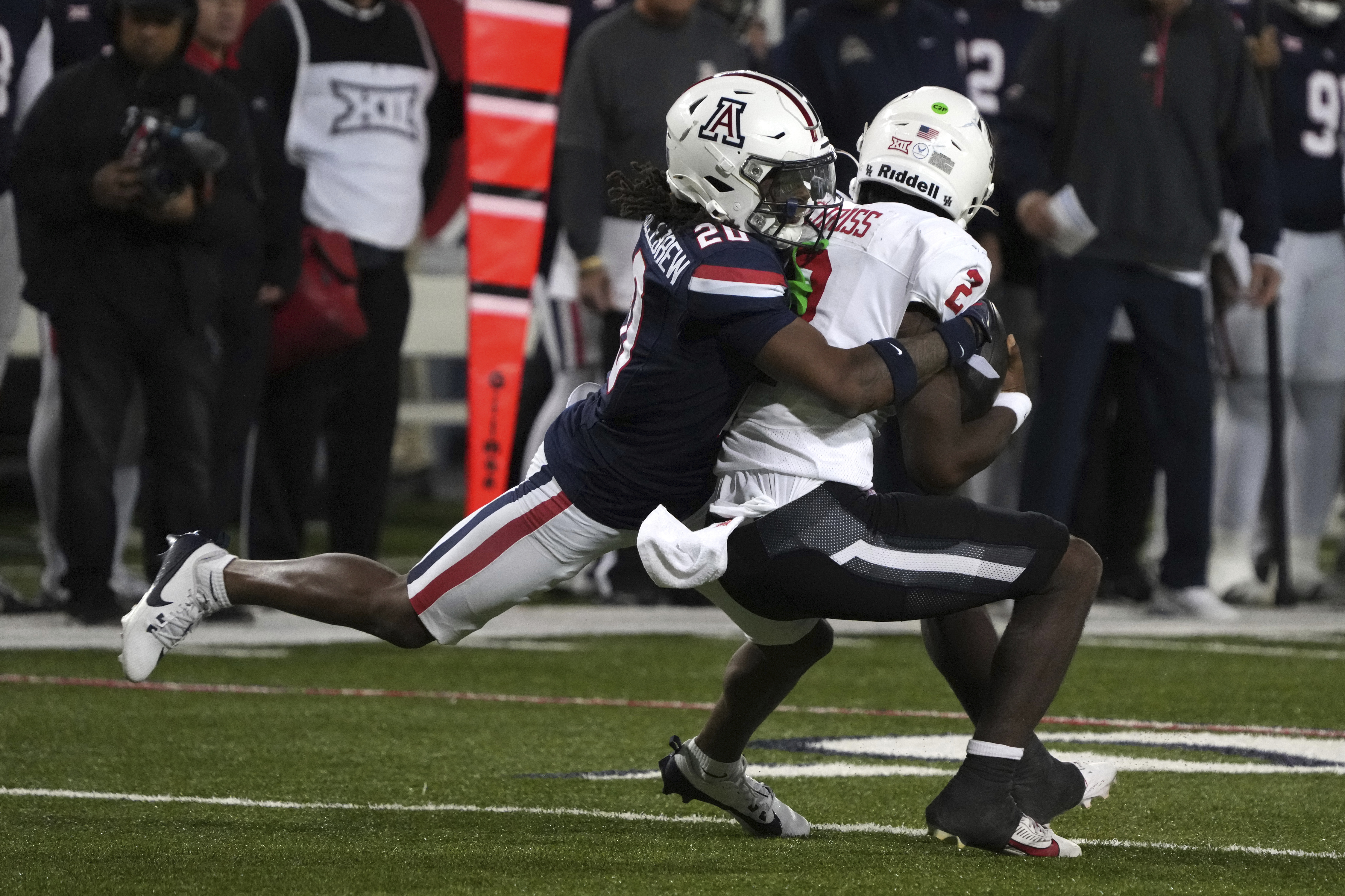 Arizona defensive back Marquis Groves-Killebrew sacks Houston quarterback Zeon Chriss (2) in the second half during an NCAA college football game, Friday, Nov. 15, 2024, in Tucson, Ariz.