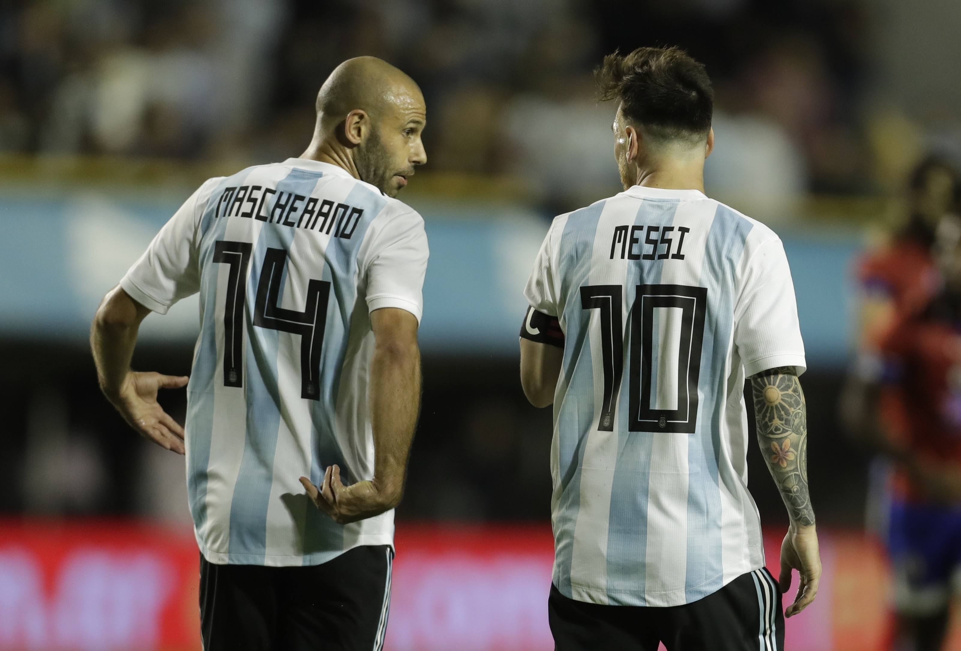 FILE - Argentina's Javier Mascherano, left, and Lionel Messi talk after Messi scored during a friendly soccer match between Argentina and Haiti in Buenos Aires, Argentina, on May 29, 2018.