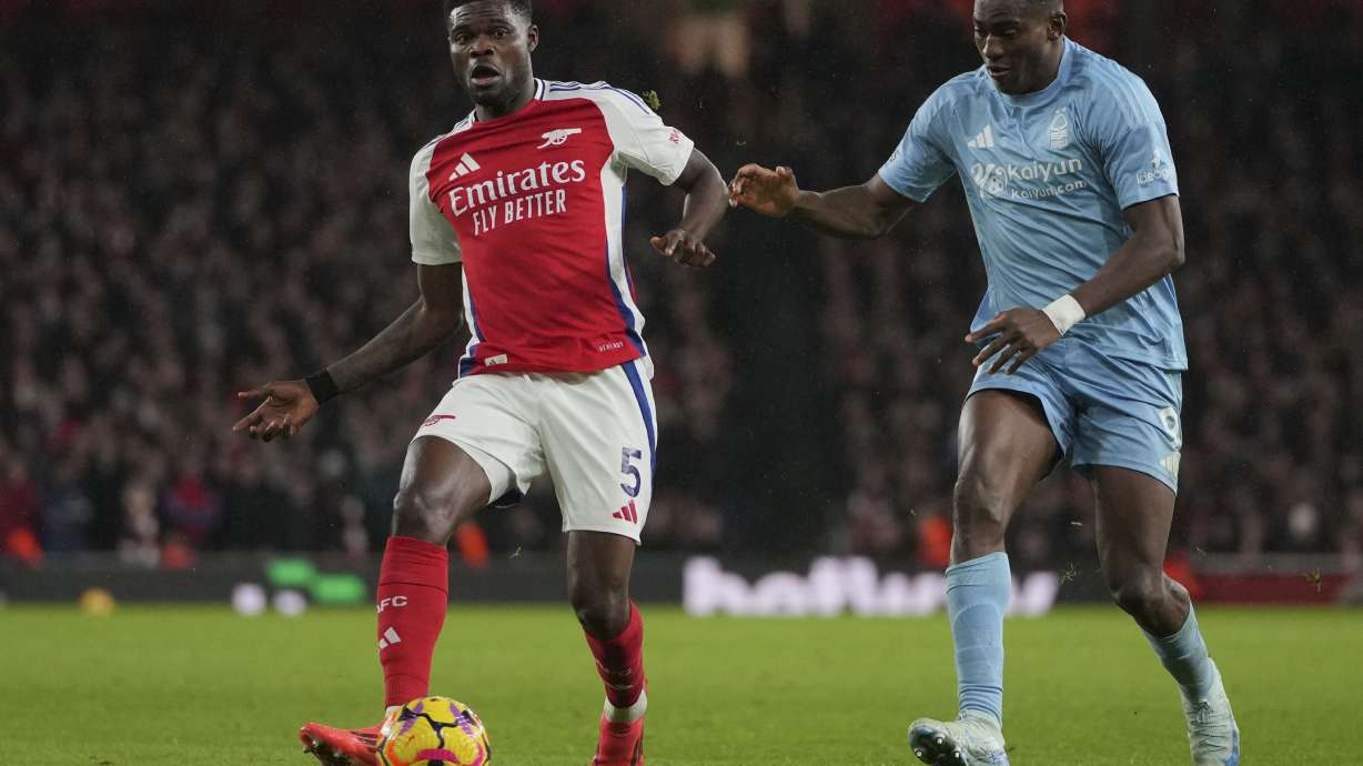 Arsenal's Thomas Partey, left, duels for the ball with Nottingham Forest's Taiwo Awoniyi during the English Premier League soccer match between Arsenal and Nottingham Forest at Emirates Stadium in London, Saturday, Nov. 23, 2024.
