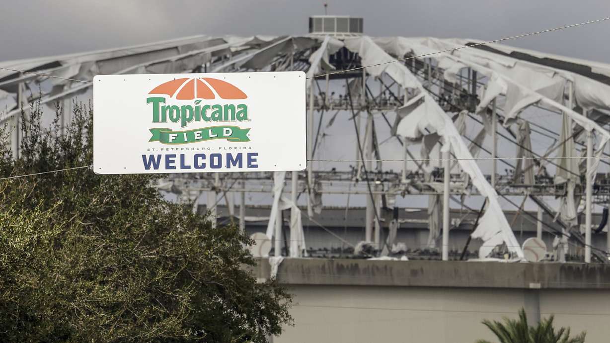 FILE - Signage at the entrance to the parking lot of Tropicana Field where the roof was torn off during Hurricane Milton on Thursday, Oct. 10, 2024, in St. Petersburg, Fla.
