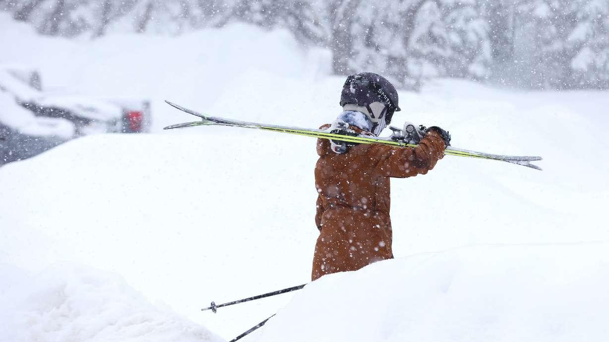 A skier walks to the lift in the newly fallen snow at Snowbird Ski Resort on Feb. 7. Snowbird was dusted with a couple of inches of snow overnight and more is expected as the Little Cottonwood Canyon prepares to open on Thanksgiving Day.