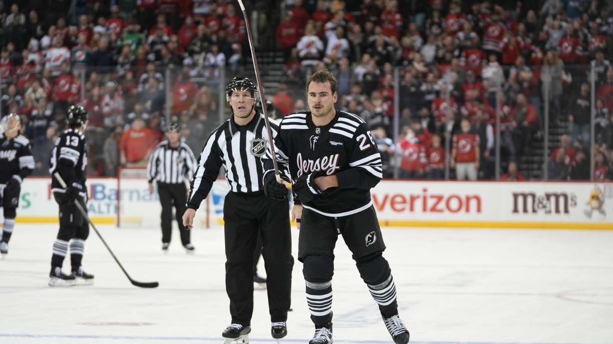 New Jersey Devils' Timo Meier, right, skates with a referee before a misconduct penalty was called against him during the third period of an NHL hockey game against the Nashville Predators, Monday, Nov. 25, 2024, in New York.