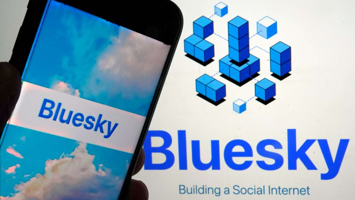 The app for Bluesky is shown on a mobile phone, left, and on a laptop screen on June 2, 2023, in New York. The social media platform is welcoming millions of new users thanks in part to a mass exodus from its former parent company, now known as X, since the presidential election.