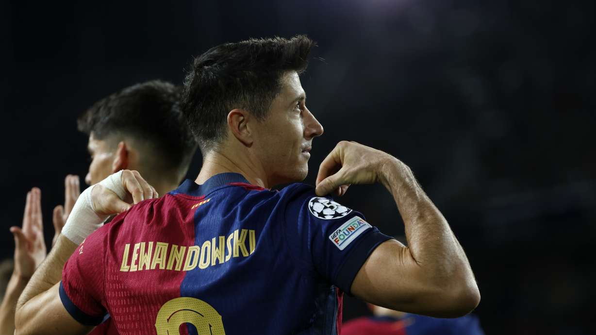 Barcelona's Robert Lewandowski celebrates after scoring his team's first goal during a Champions League phase soccer Matchday 5 between Barcelona and Brest at the Lluis Companys Olympic Stadium in Barcelona, Spain, Tuesday, Nov. 26, 2024.
