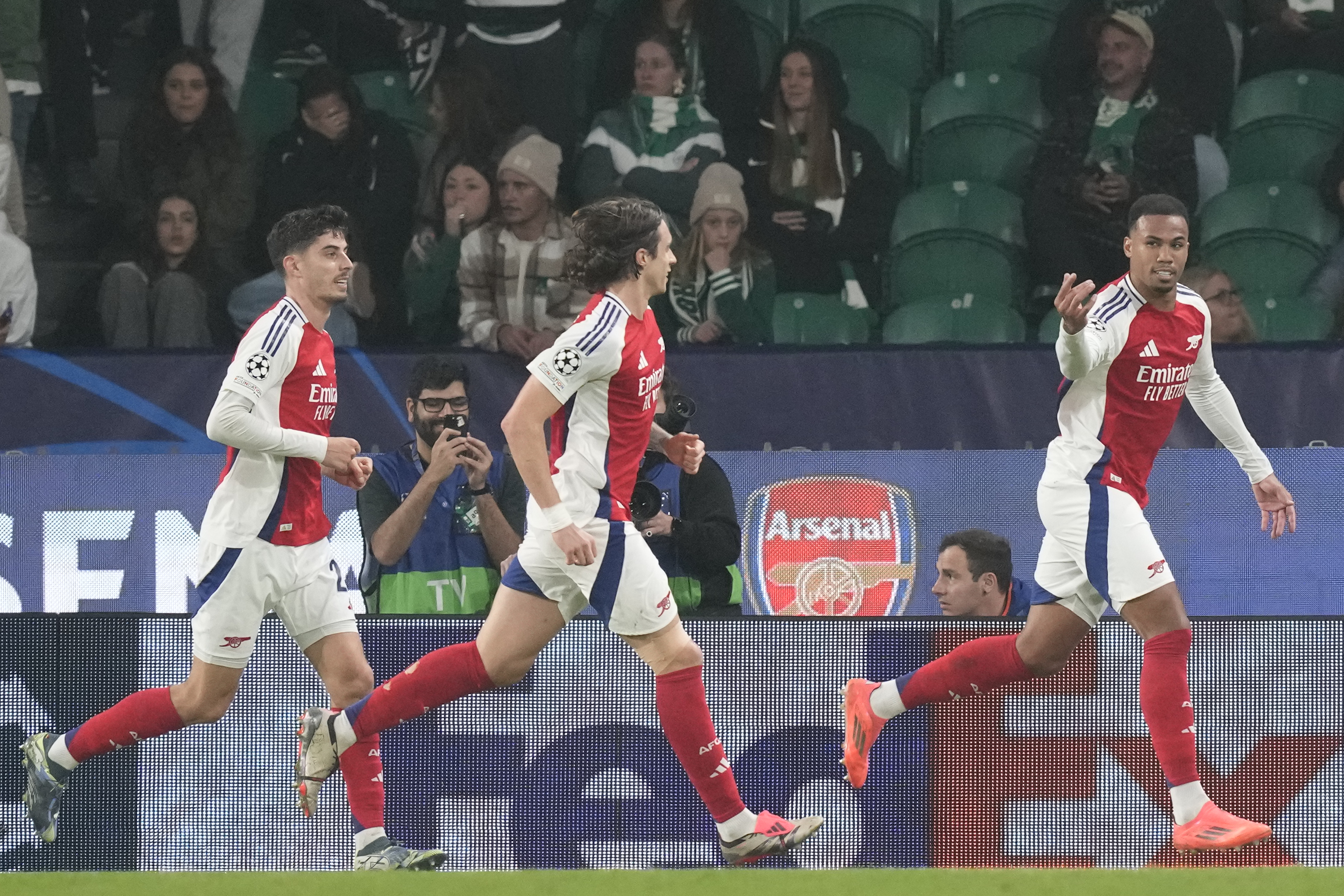 Arsenal's Gabriel, right, celebrates after scoring his side's 3nd goal against Sporting during the Champions League opening phase soccer match at the Alvalade stadium in Lisbon, Tuesday, Nov. 26, 2024.