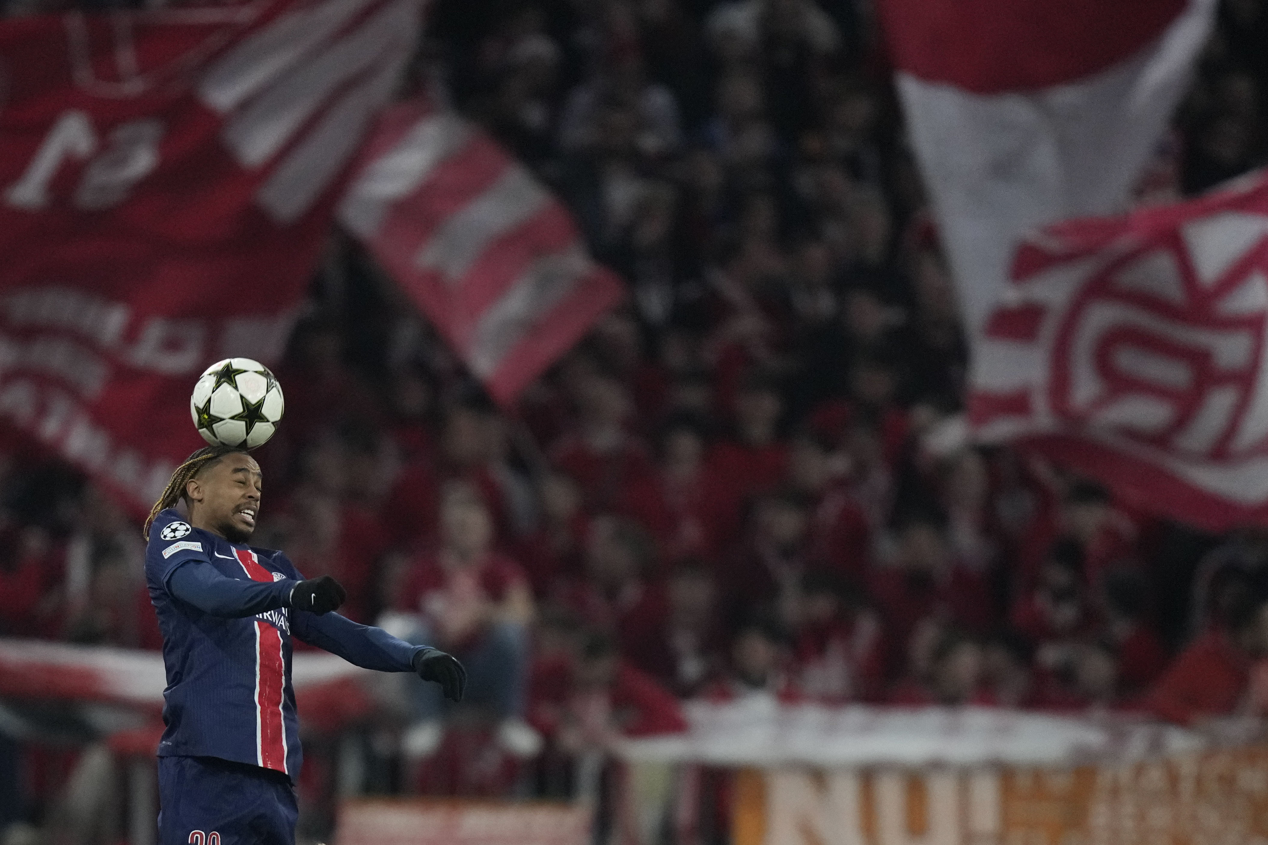 PSG's Bradley Barcola heads the ball during the Champions League opening phase soccer match between FC Bayern and Paris Saint Germain, at the Allianz Arena in Munich, Germany, Tuesday, Nov. 26, 2024.