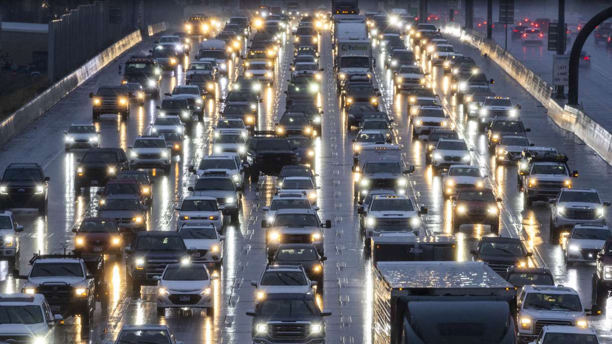Cars sit in traffic on southbound I-15 in Salt Lake City on Tuesday. Utah's average fuel price slipped below the national average this week, just in time for the busy Thanksgiving holiday travel period.