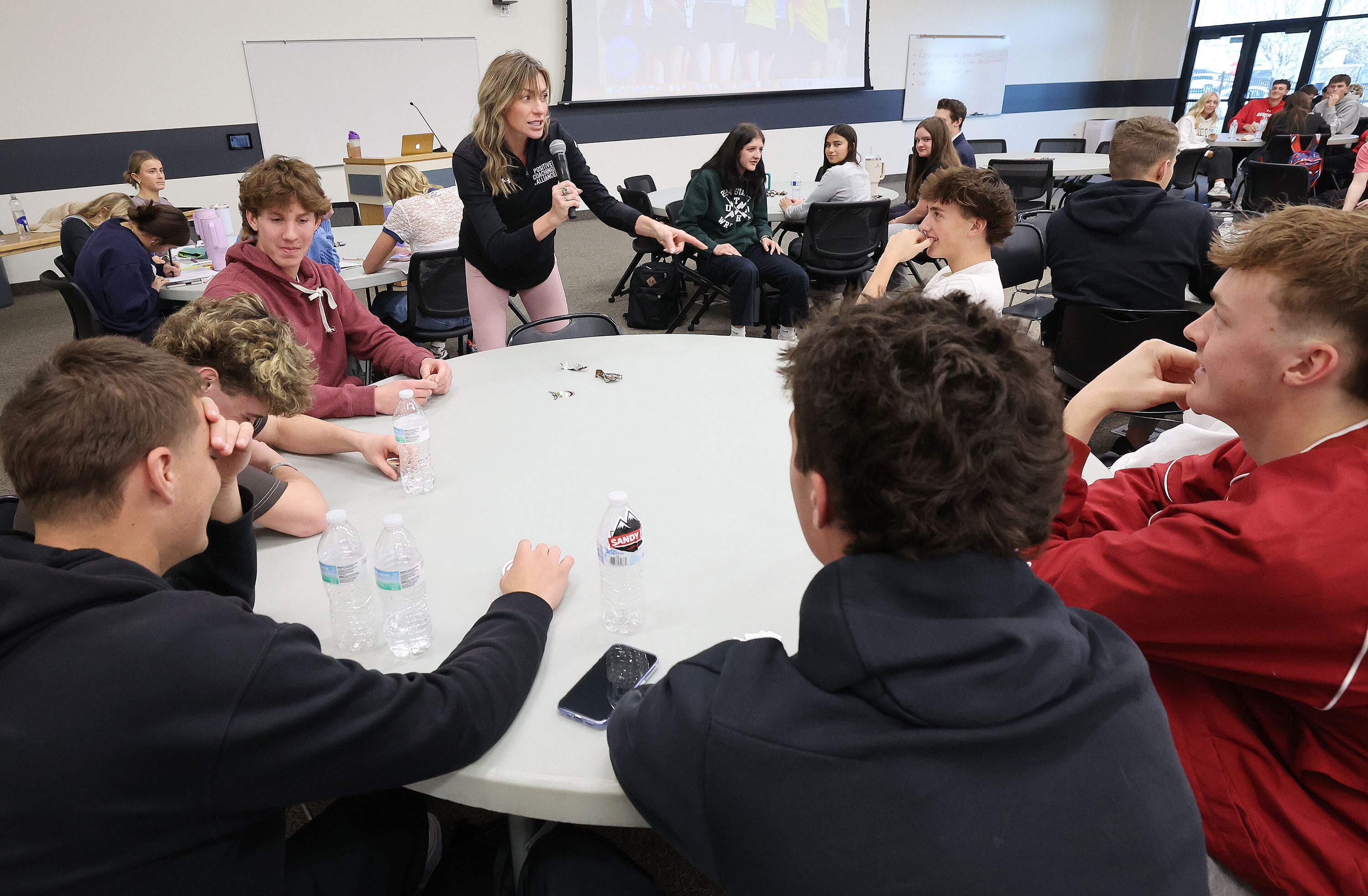 Jessica Crate Oveson talks with varsity sports captains from Jordan District high schools gathering for a district-sponsored workshop and training to improve the experience for high school student-athletes at Jordan District JATC Riverton Campus in Riverton on Tuesday, Nov. 19, 2024.