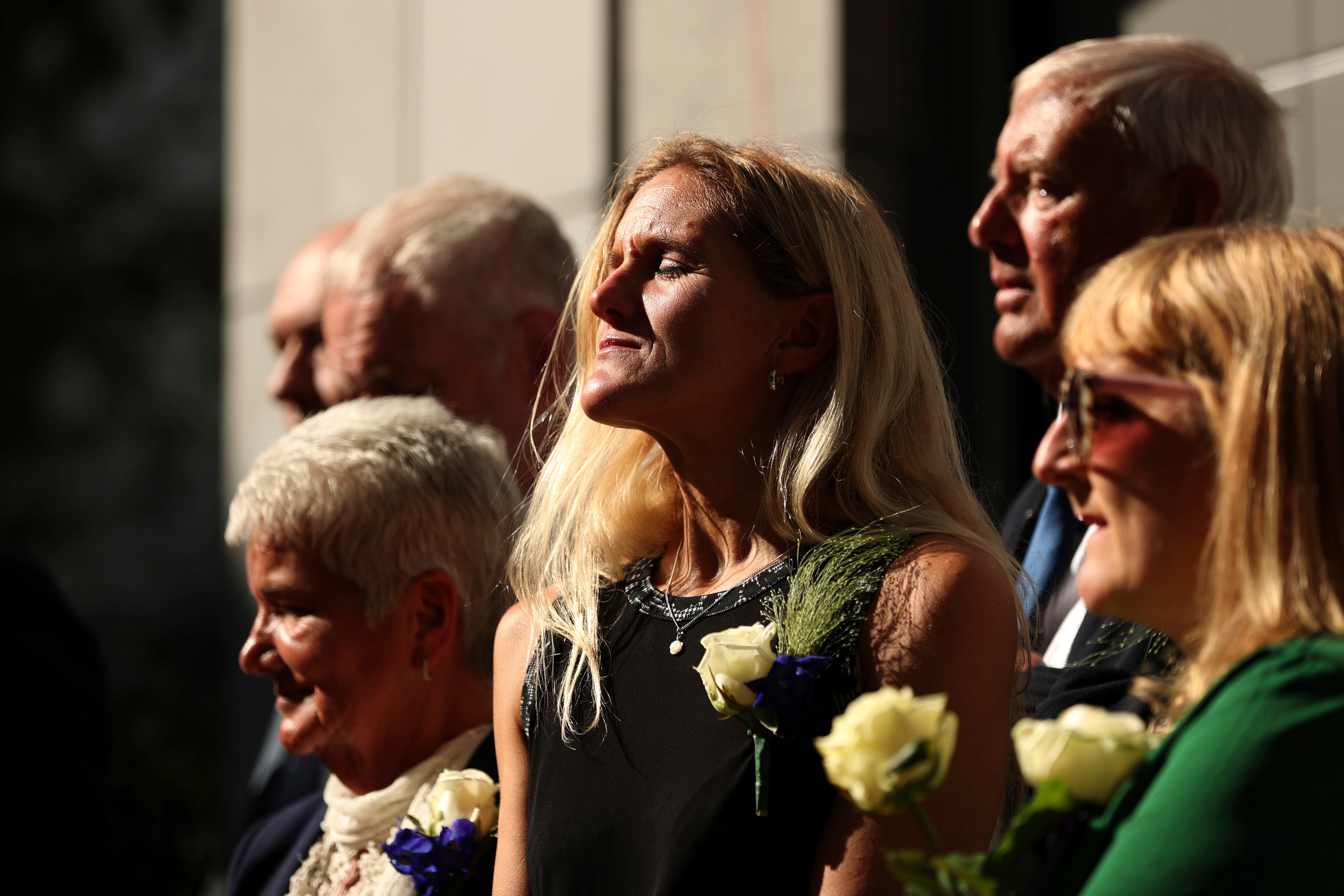 Britain Labour Party MP Kim Leadbeater, center, listens to songs next to her parents Jean, left, and Gordon, rear right, during the official inauguration of Jo Cox Square in the center of Brussels, Sept. 27, 2018. The United Kingdom may become the next country to legalize assisted suicide.