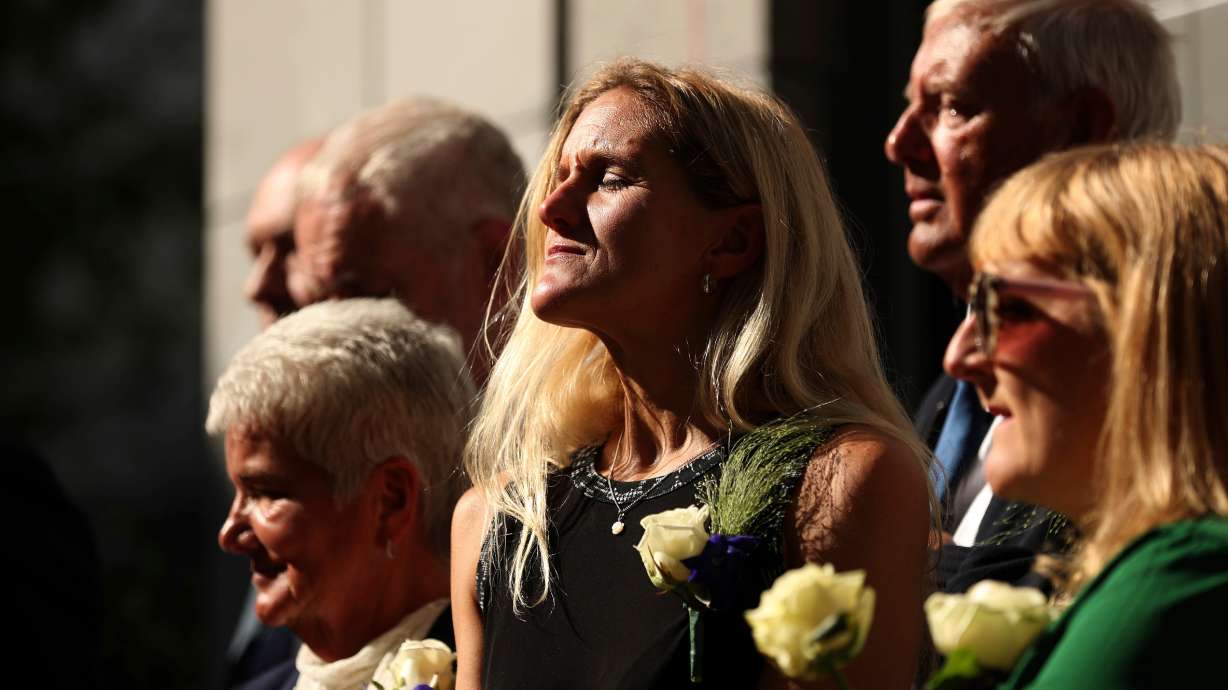Britain Labour Party MP Kim Leadbeater, center, listens to songs next to her parents Jean, left, and Gordon, rear right, during the official inauguration of Jo Cox Square in the center of Brussels, Sept. 27, 2018. The United Kingdom may become the next country to legalize assisted suicide.