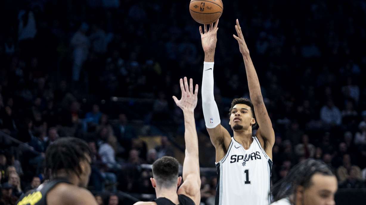 San Antonio Spurs center Victor Wembanyama (1) shoots while guarded by Utah Jazz forward Drew Eubanks (15) during an NBA basketball game held at the Delta Center in Salt Lake City on Tuesday, Nov. 26, 2024.