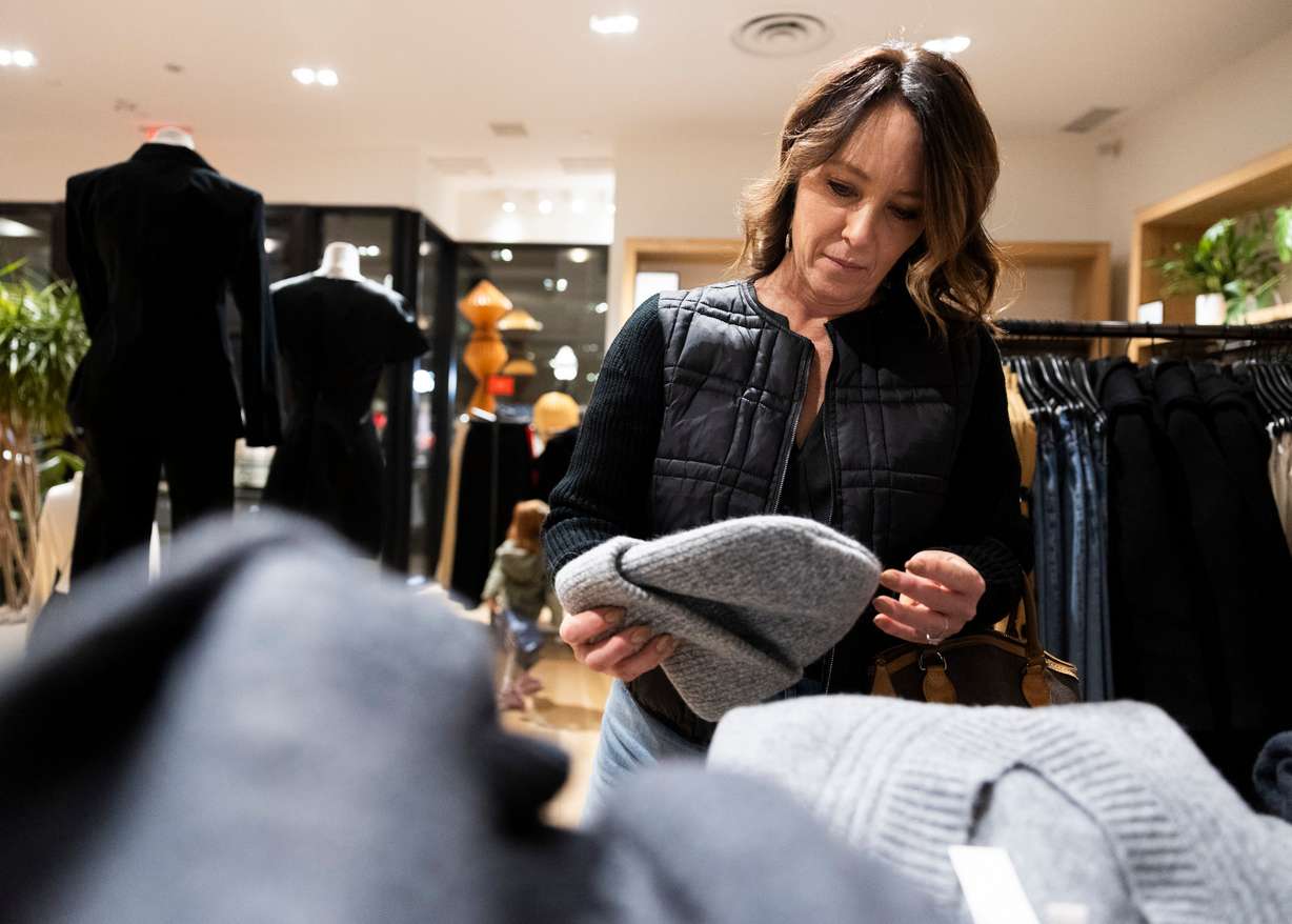 Makell Westenskow looks at clothing while shopping at J.Crew in City Creek Center in Salt Lake City on Friday, Nov. 22.