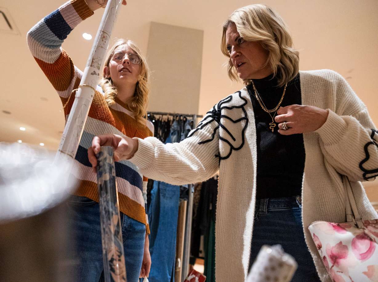 Tenille Philips, right, looks through gift wrapping paper with her daughter Mallory Philips, 14, while shopping at Anthropologie in City Creek Center in Salt Lake City on Friday, Nov. 22.