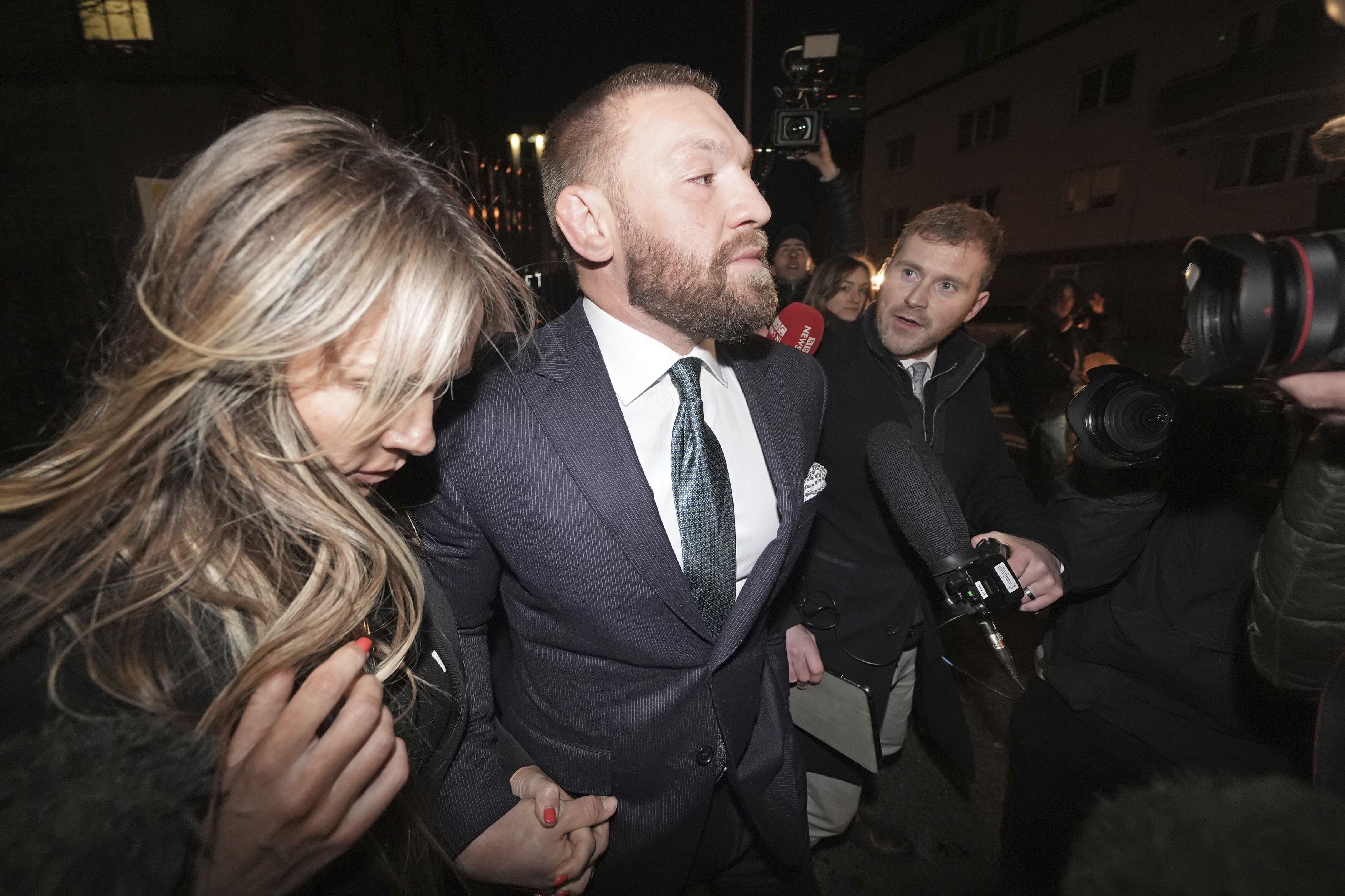 Mixed martial arts fighter Conor McGregor and partner Dee Devlin leave the High Court in Dublin, Ireland, Friday Nov. 22, 2024.