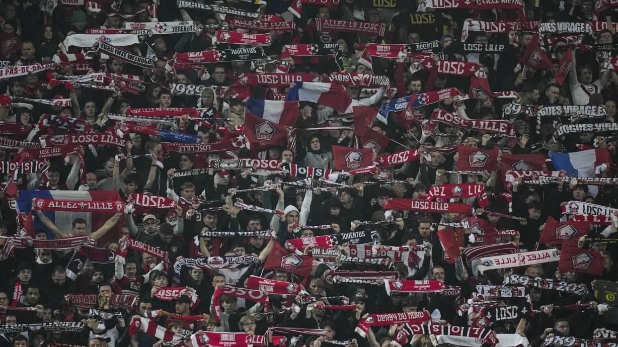 Lille's fans hold up their scarfs during the Champions League opening phase soccer match between Lille and Juventus at the Stade Pierre Mauroy in Villeneuve-d'Ascq, outside Lille, France, Tuesday, Nov. 5, 2024.