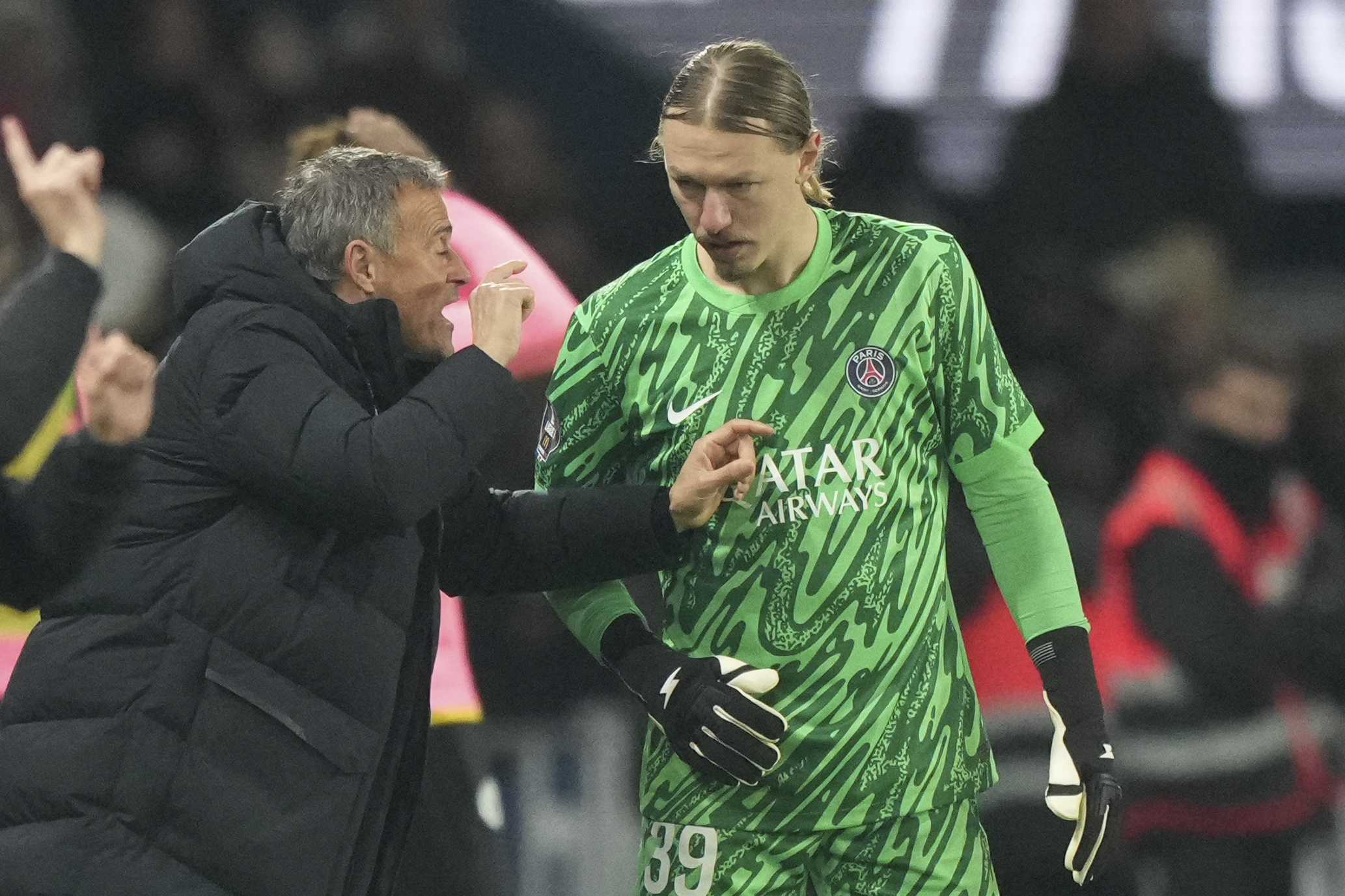 PSG's head coach Luis Enrique talks to goalkeeper Matvey Safonov during the French League One soccer match between Paris Saint-Germain and Toulouse at the Parc des Princes stadium in Paris, France, Sunday, Nov. 22, 2024.