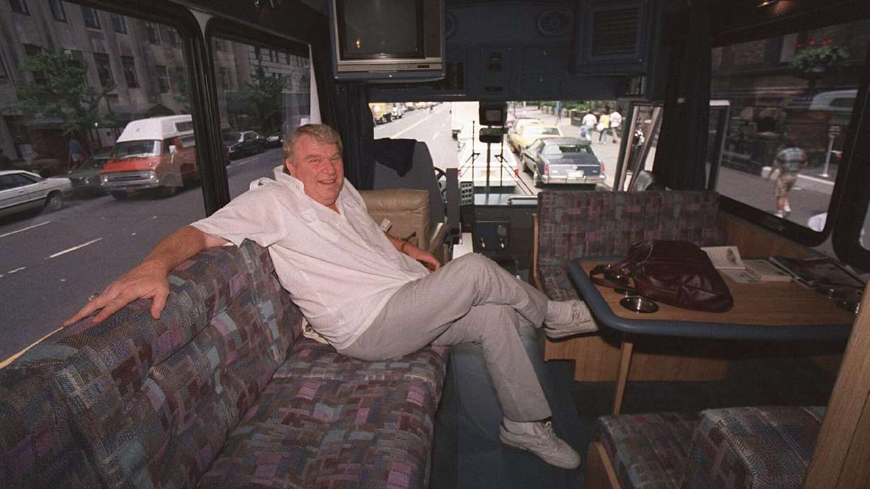 FILE - TV sports personality and former Oakland Raiders head coach John Madden enjoys the comforts of his custom-made bus while in New York June 10, 1987.