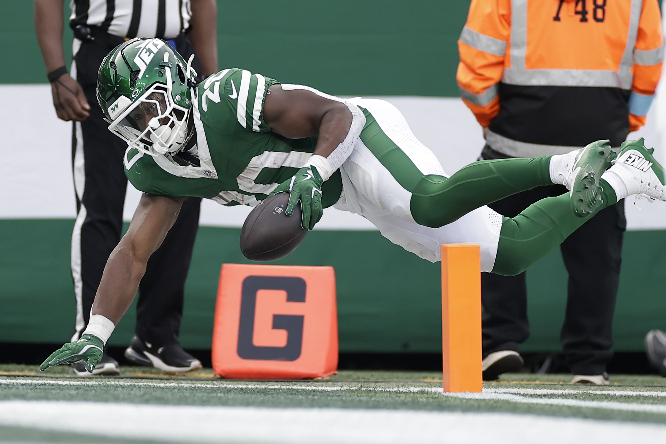 New York Jets running back Breece Hall (20) reaches the ball across the goal line for a touchdown against the Indianapolis Colts during the third quarter of an NFL football game, Sunday, Nov. 17, 2024, in East Rutherford, N.J. 