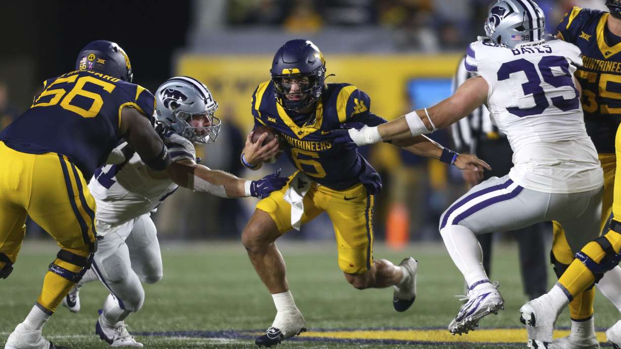 FILE - West Virginia quarterback Garrett Greene (6) rushes the ball against Kansas State during the frist half of an NCAA college football game, Saturday, Oct. 19, 2024, in Morgantown, W.Va.