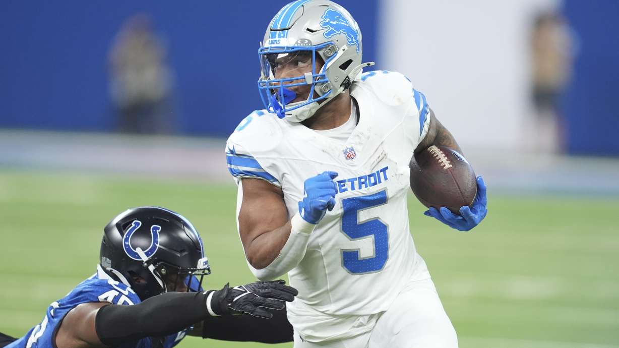 Detroit Lions running back David Montgomery (5) pulls away from Indianapolis Colts linebacker E.J. Speed (45) during the first half of an NFL football game, Sunday, Nov. 24, 2024, in Indianapolis.