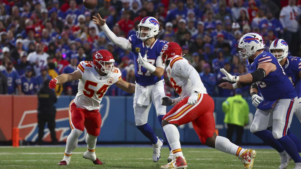 Buffalo Bills quarterback Josh Allen throws as Kansas City Chiefs linebacker Leo Chenal (54) defends during the first half of an NFL football game Sunday, Nov. 17, 2024, in Orchard Park, N.Y.