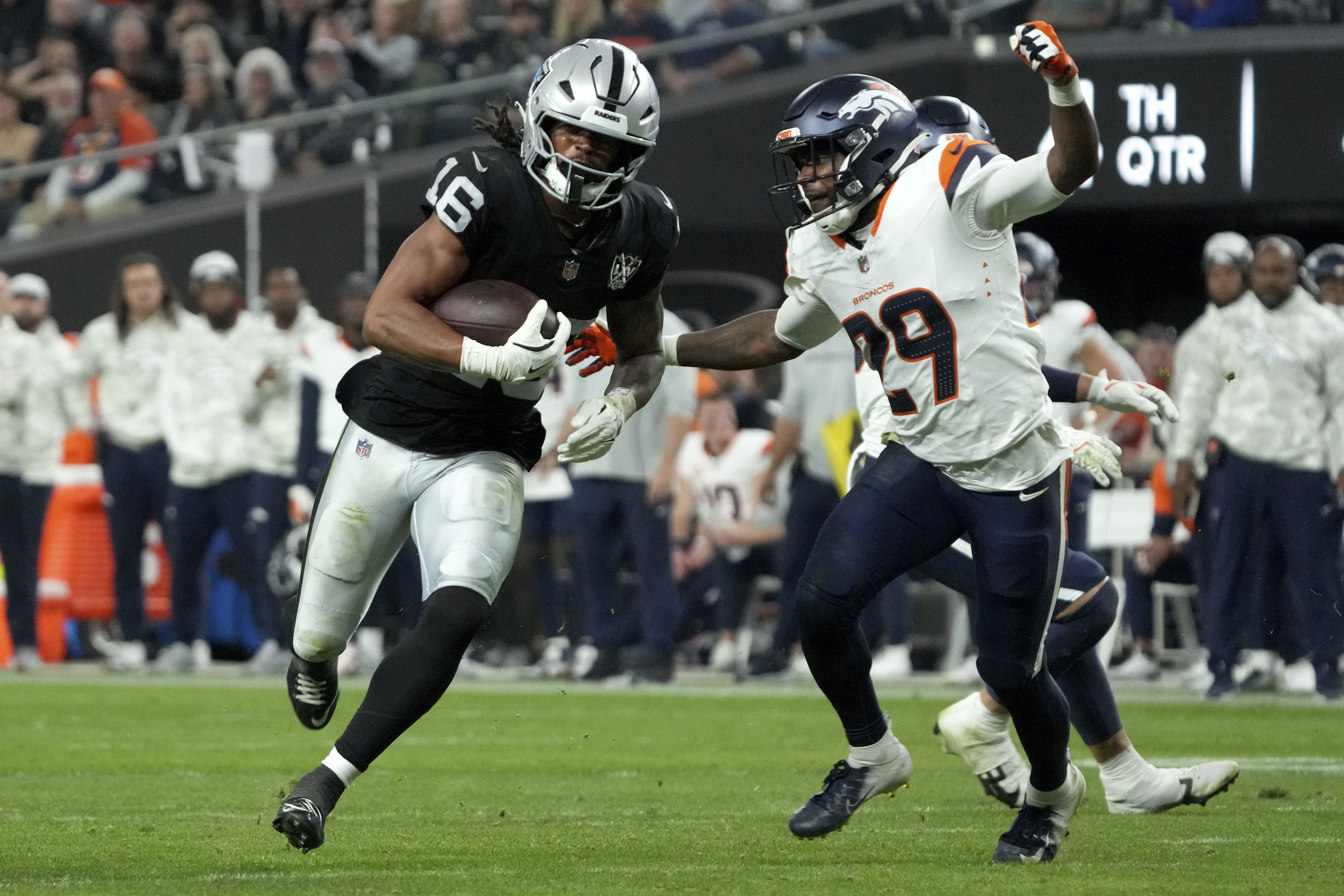 Las Vegas Raiders wide receiver Jakobi Meyers (16) runs after the catch as Denver Broncos cornerback Ja'Quan McMillian (29) defends during the second half of an NFL football game, Sunday, Nov. 24, 2024, in Las Vegas.