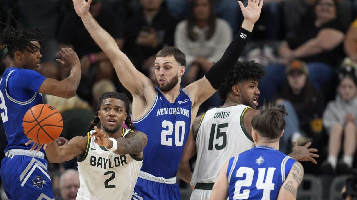 Baylor guard Jayden Nunn (2) passes the ball out as New Orleans' Luke Davis (20) and Kohen Rowbatham (24) defend in the second half of an NCAA college basketball game Wednesday, Nov. 27, 2024, in Waco, Texas.