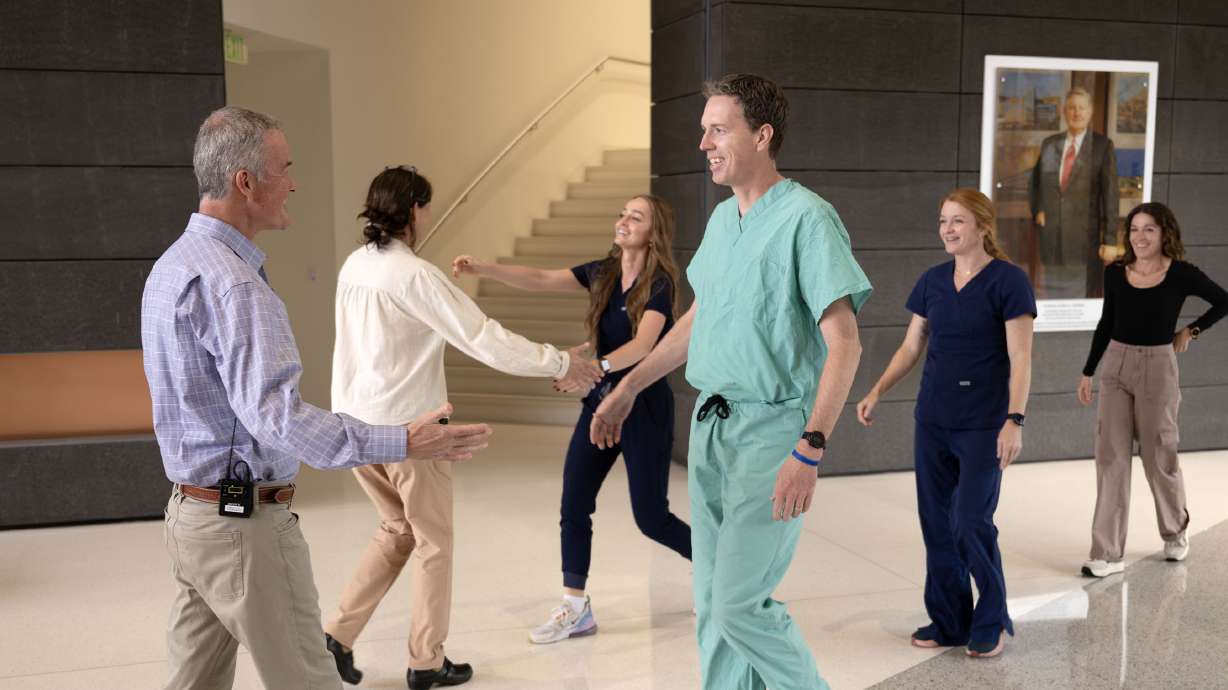 Dan Sorensen walks toward Dr. Mike Henstrom of Intermountain Medical Center, as they are reunited with the people who saved his life and were also medical professionals Tuesday in Murray.