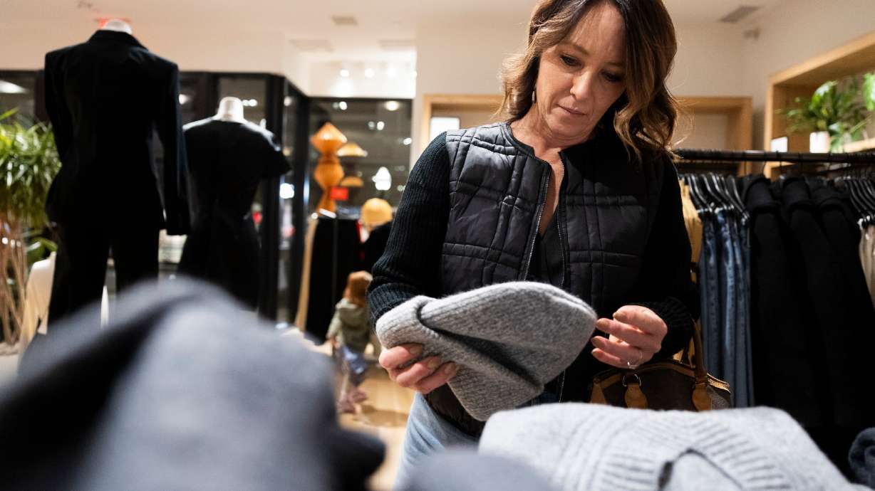 Makell Westenskow looks at clothing while shopping at J.Crew in City Creek Center in Salt Lake City on Friday. Cyber sales for the first 24 days of November exceeded $77 billion and are on track to far surpass record holiday spending predictions.