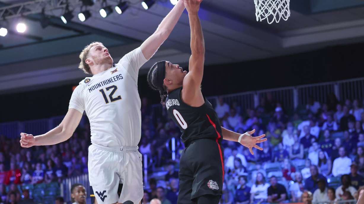 In this handout provided by Bahamas Visual Services, Gonzaga guard Ryan Nembhard (0) goes to the basket against West Virginia guard Tucker DeVries (12) during an NCAA college basketball game at the Battle 4 Atlantis tournament in Paradise Island, Bahamas Wednesday, Nov. 27, 2024.