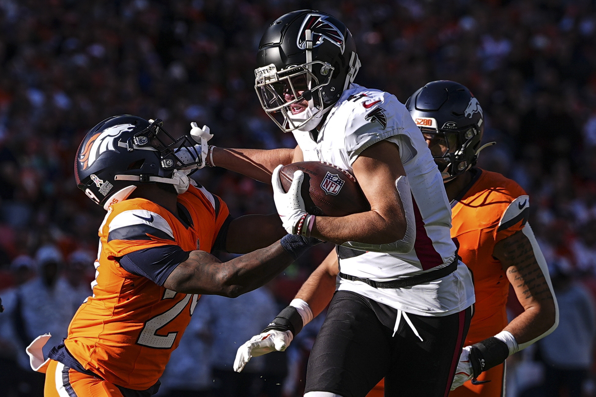 Atlanta Falcons wide receiver Drake London (5) makes the catch against Denver Broncos cornerback Ja'Quan McMillian (29) during the first half of an NFL football game, Sunday, Nov. 17, 2024, in Denver. 
