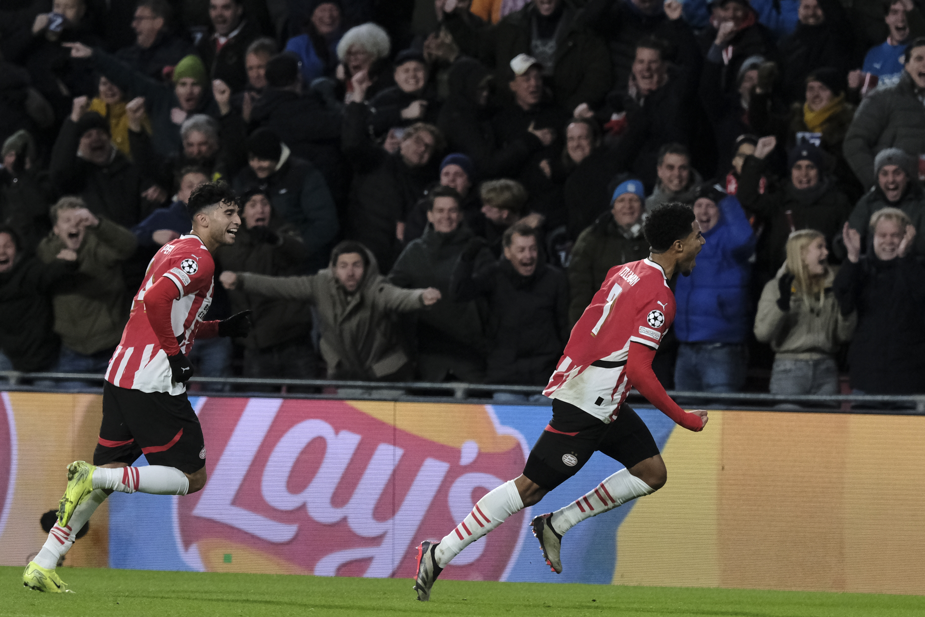 PSV's Malik Tillman, right, celebrates after scoring his sides first goal during the Champions League opening phase soccer match between PSV Eindhoven and Shakhtar Donetsk at the PSV Stadium in Eindhoven, Netherlands, Wednesday, Nov. 27, 2024.