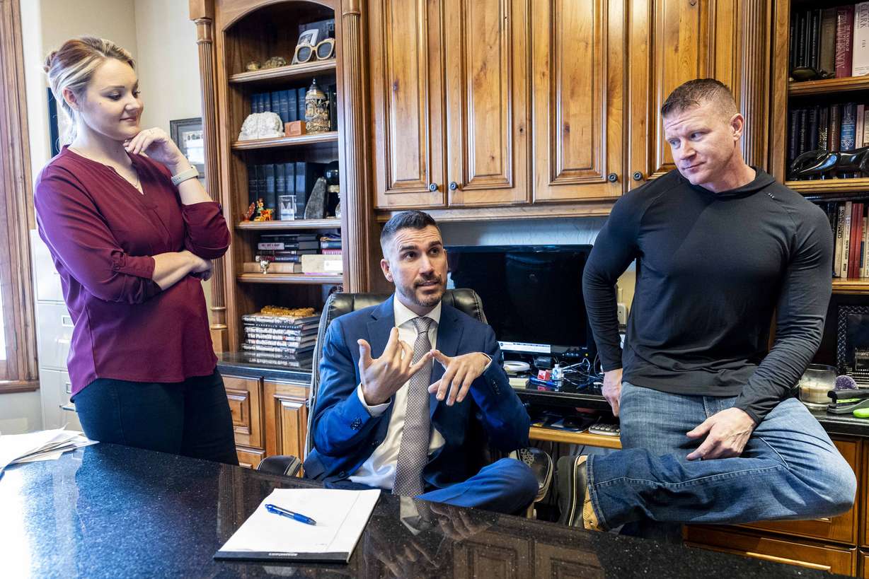 Attorney Thomas Hutchings, center, talks with a KSL.com reporter, not pictured, as Hutchings is joined by his clients, Sarah and Andy Figorski, in Salt Lake County on Wednesday.