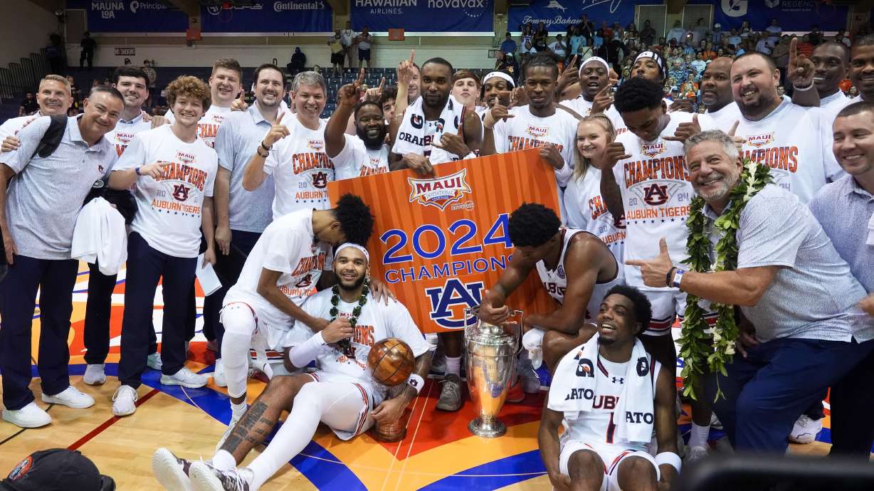 Auburn players and staff celebrate a 90-76 win over Memphis in the championship game of the NCAA college basketball Maui Invitational tournament, Wednesday, Nov. 27, 2024, in Lahaina, Hawaii.