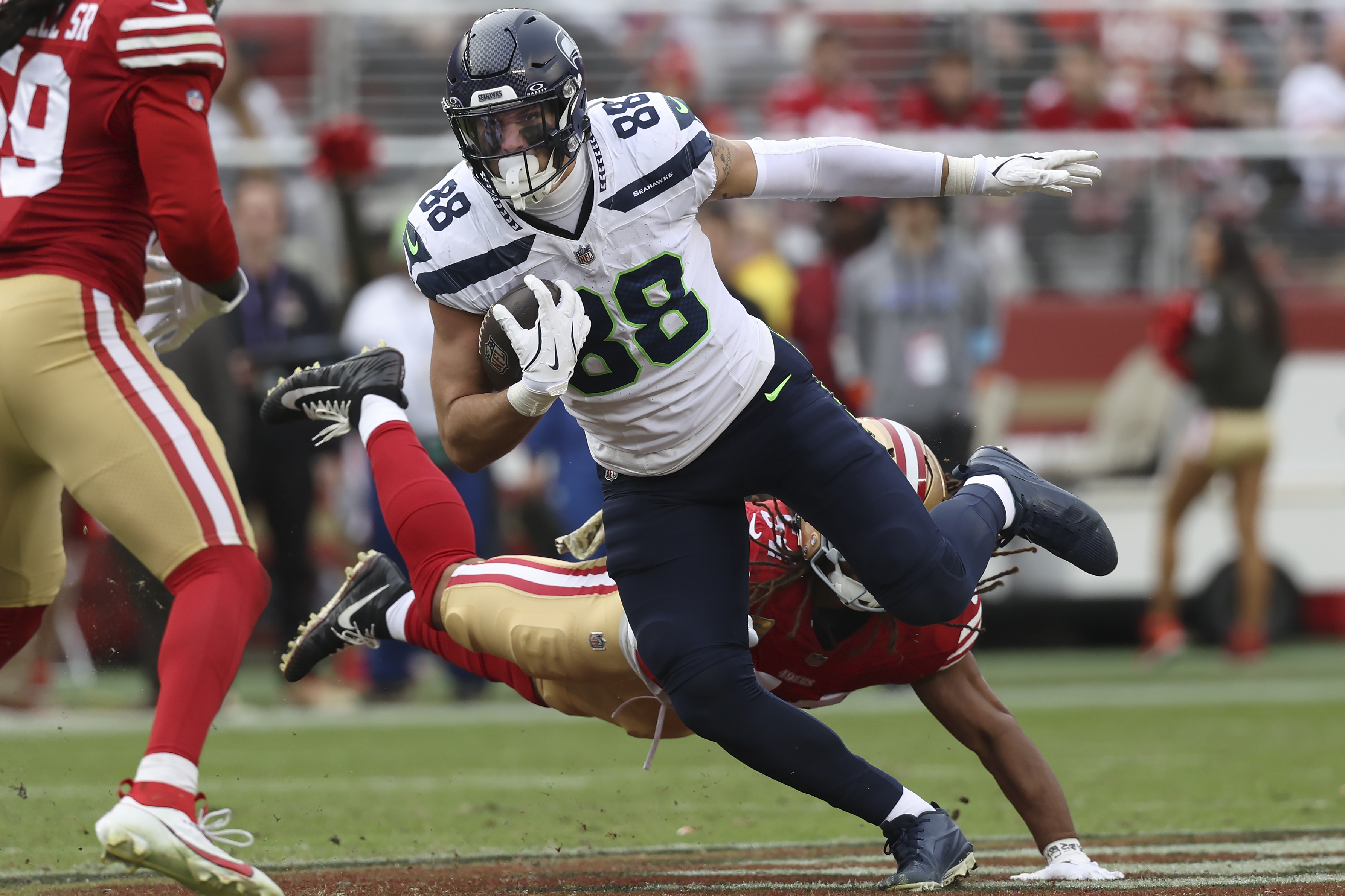 Seattle Seahawks tight end AJ Barner (88) runs against San Francisco 49ers linebacker Fred Warner, bottom, during the second half of an NFL football game in Santa Clara, Calif., Sunday, Nov. 17, 2024. 