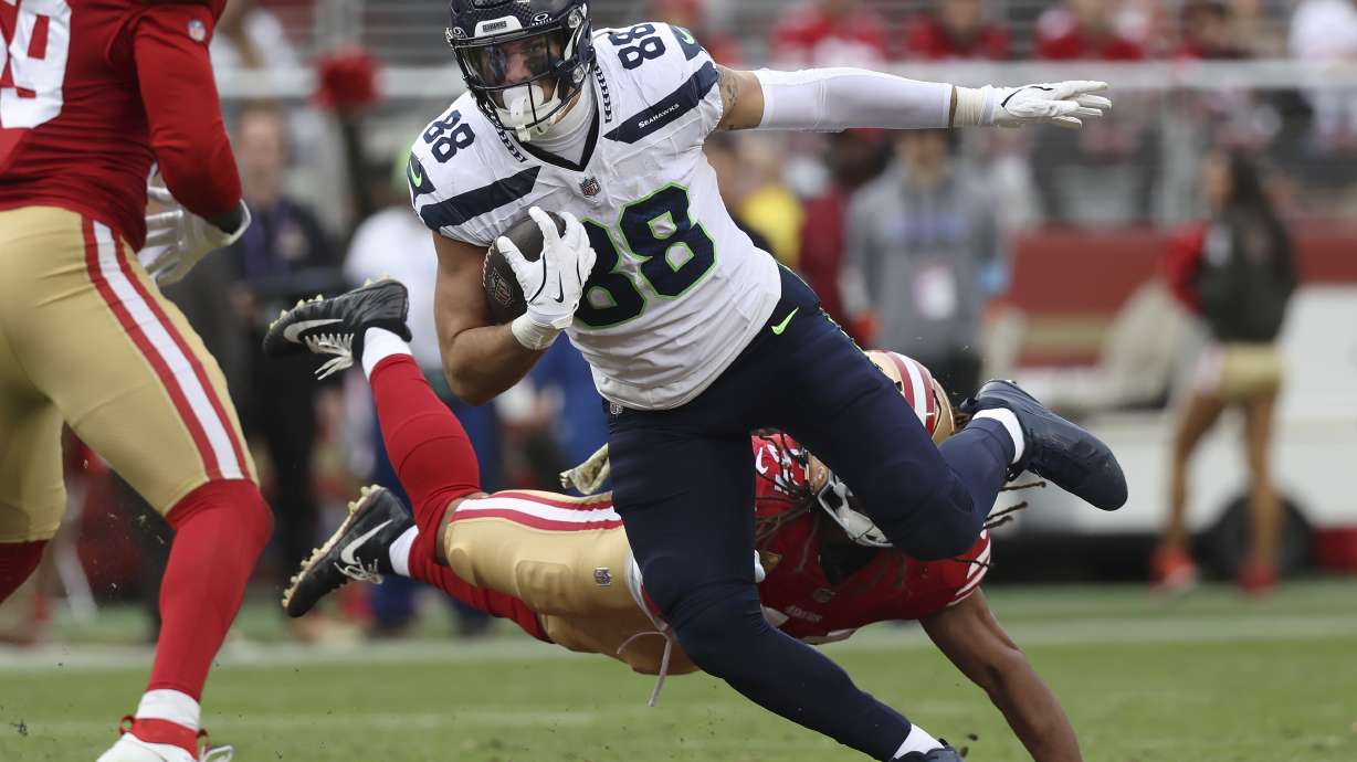 Seattle Seahawks tight end AJ Barner (88) runs against San Francisco 49ers linebacker Fred Warner, bottom, during the second half of an NFL football game in Santa Clara, Calif., Sunday, Nov. 17, 2024.