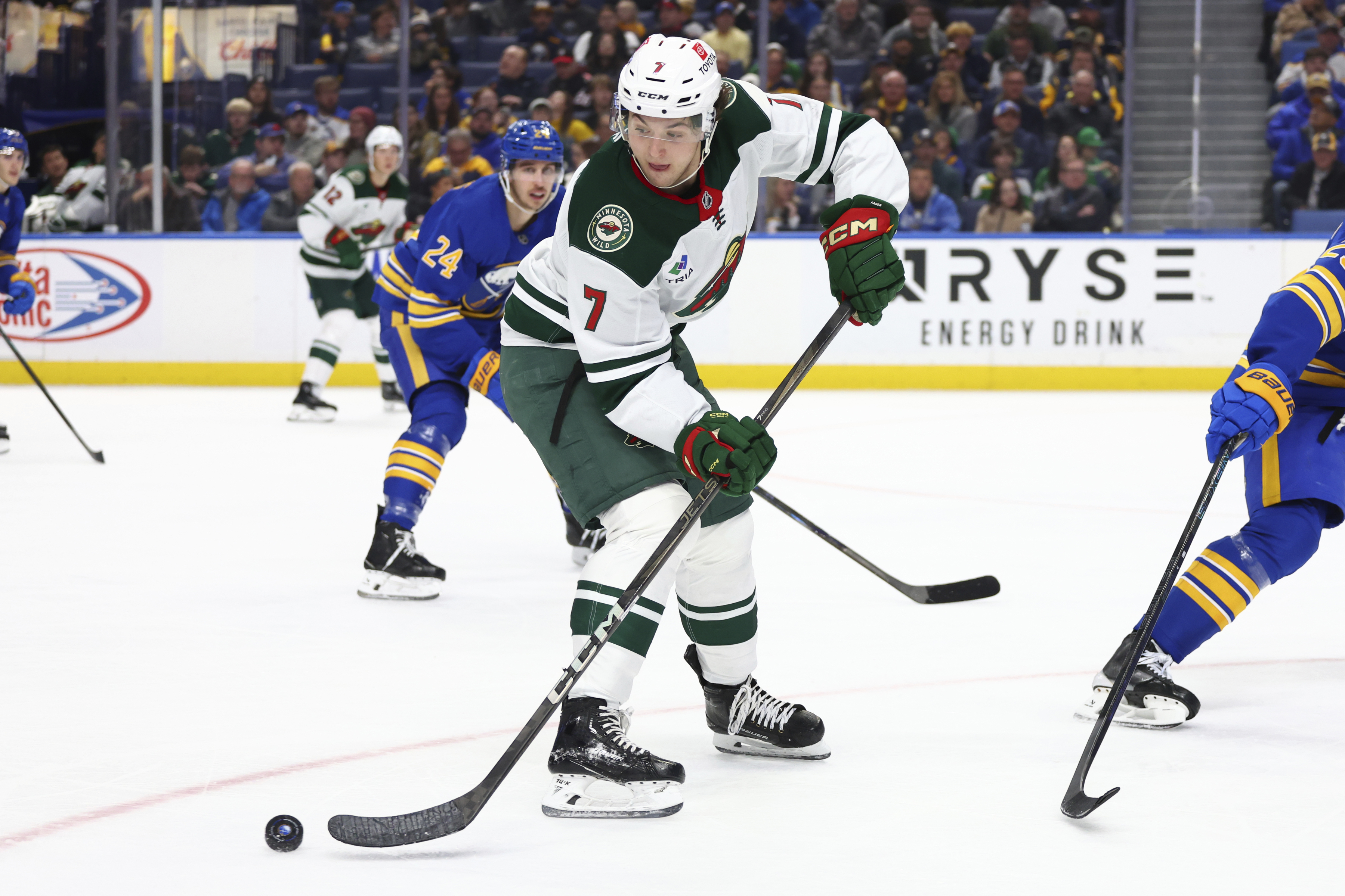 Minnesota Wild defenseman Brock Faber (7) passes the puck during the second period of an NHL hockey game against the Buffalo Sabres, Wednesday, Nov. 27, 2024, in Buffalo, N.Y.