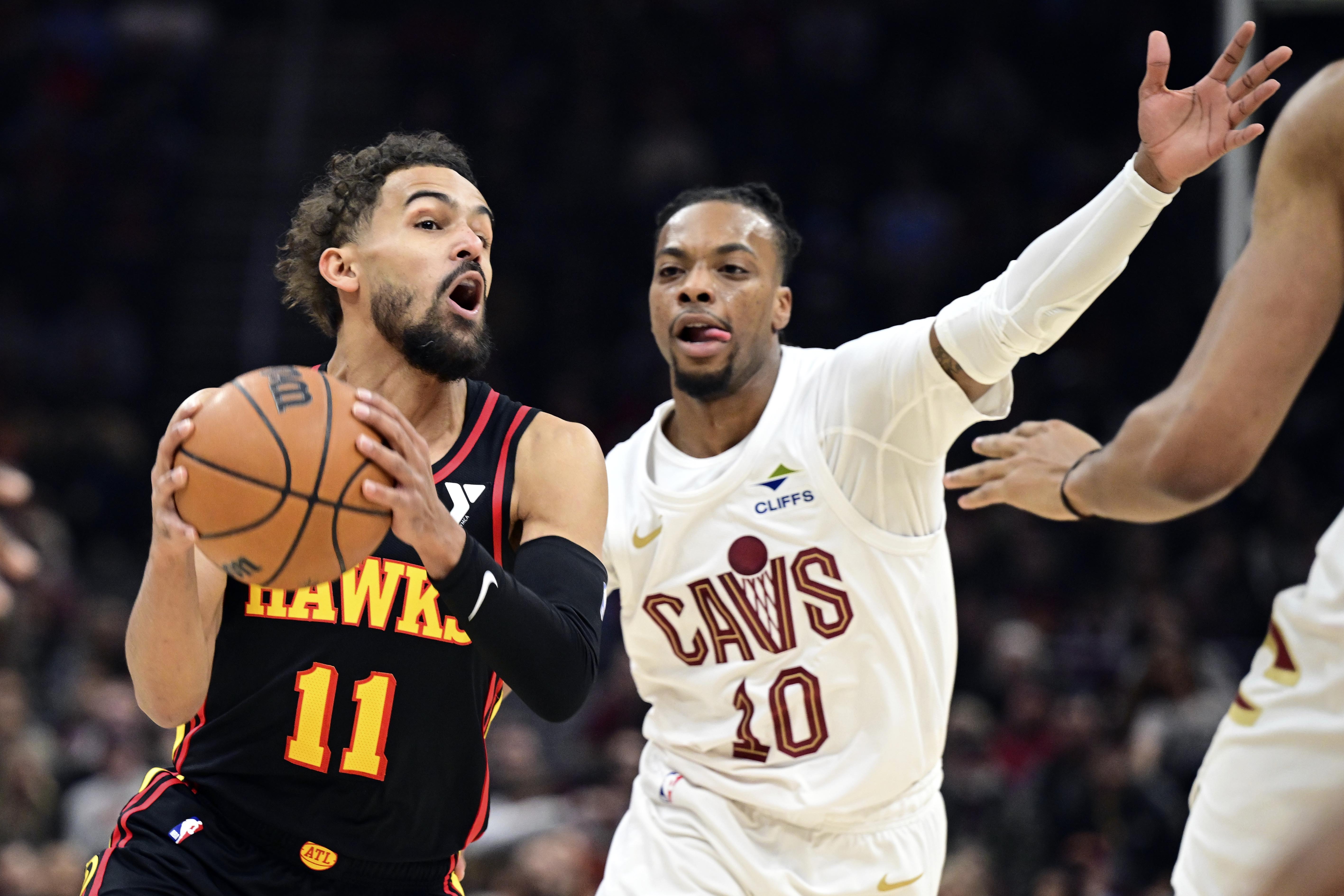 Atlanta Hawks guard Trae Young drives on Cleveland Cavaliers guard Darius Garland in the first half of an NBA basketball game, Wednesday, Nov. 27, 2024, in Cleveland.