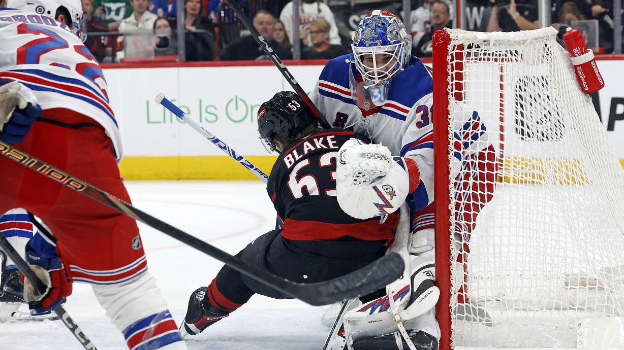 Carolina Hurricanes' Jackson Blake collides with New York Rangers goaltender Igor Shesterkin (31) during the second period of an NHL hockey game in Raleigh, N.C., Wednesday, Nov. 27, 2024.